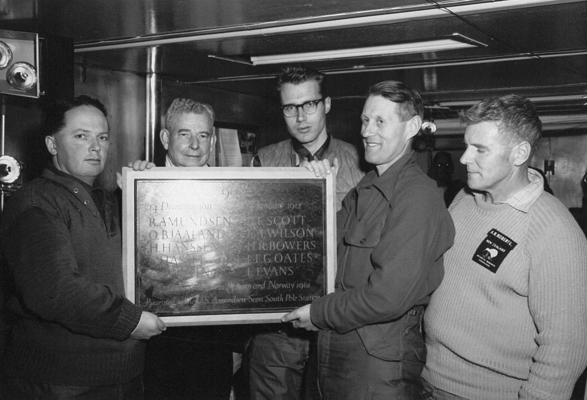 Men holding a plaque.