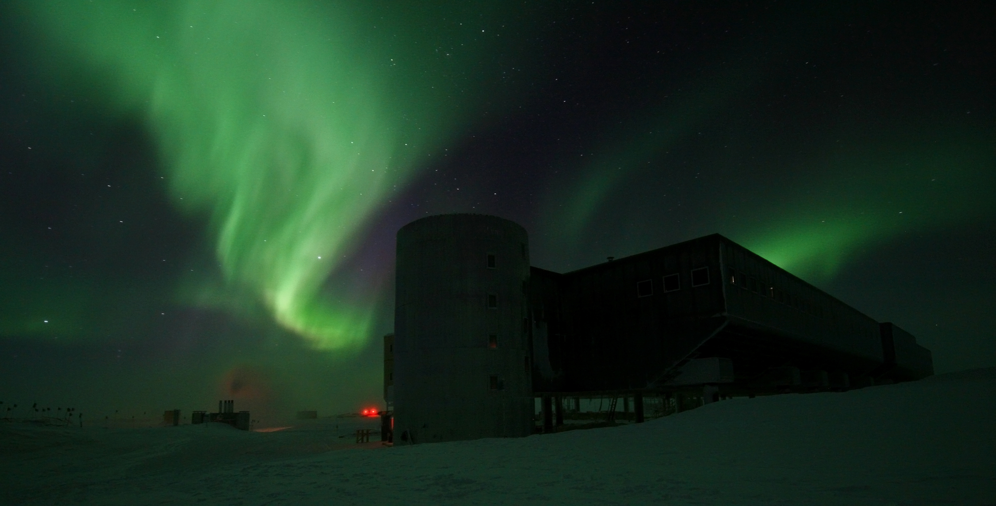 Aurora in night sky over the South Pole Station.