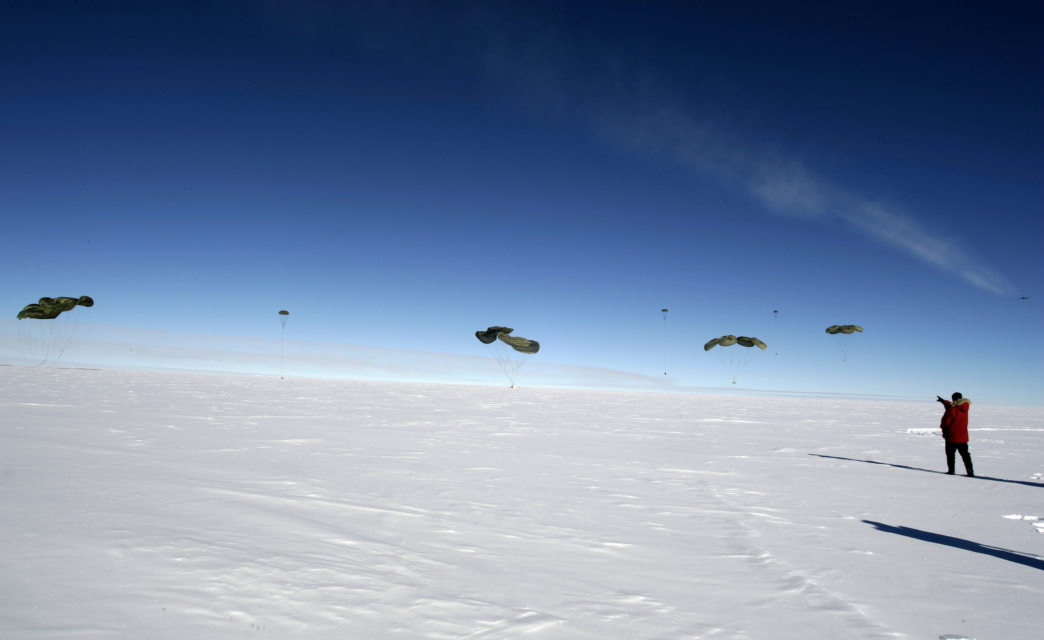 Parachutes over snow.