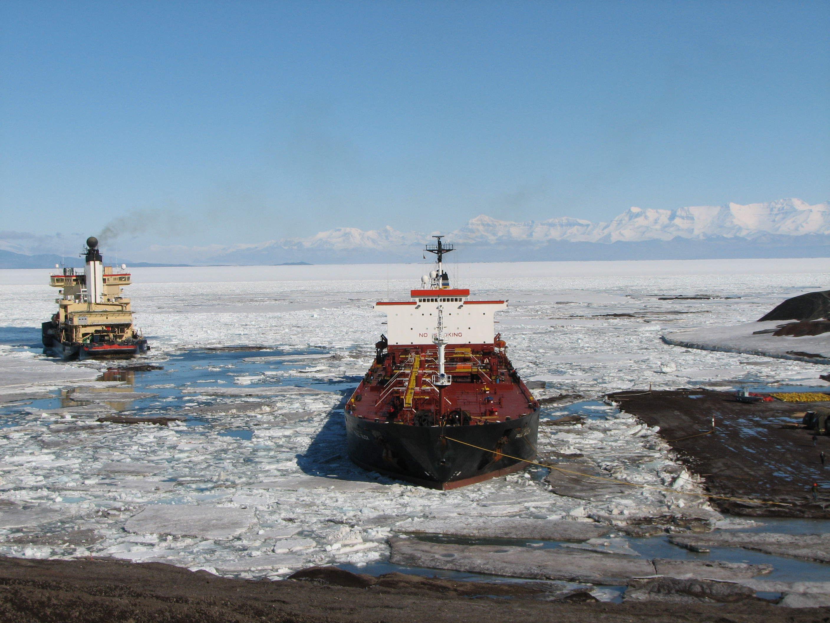 Two ships in icy water.
