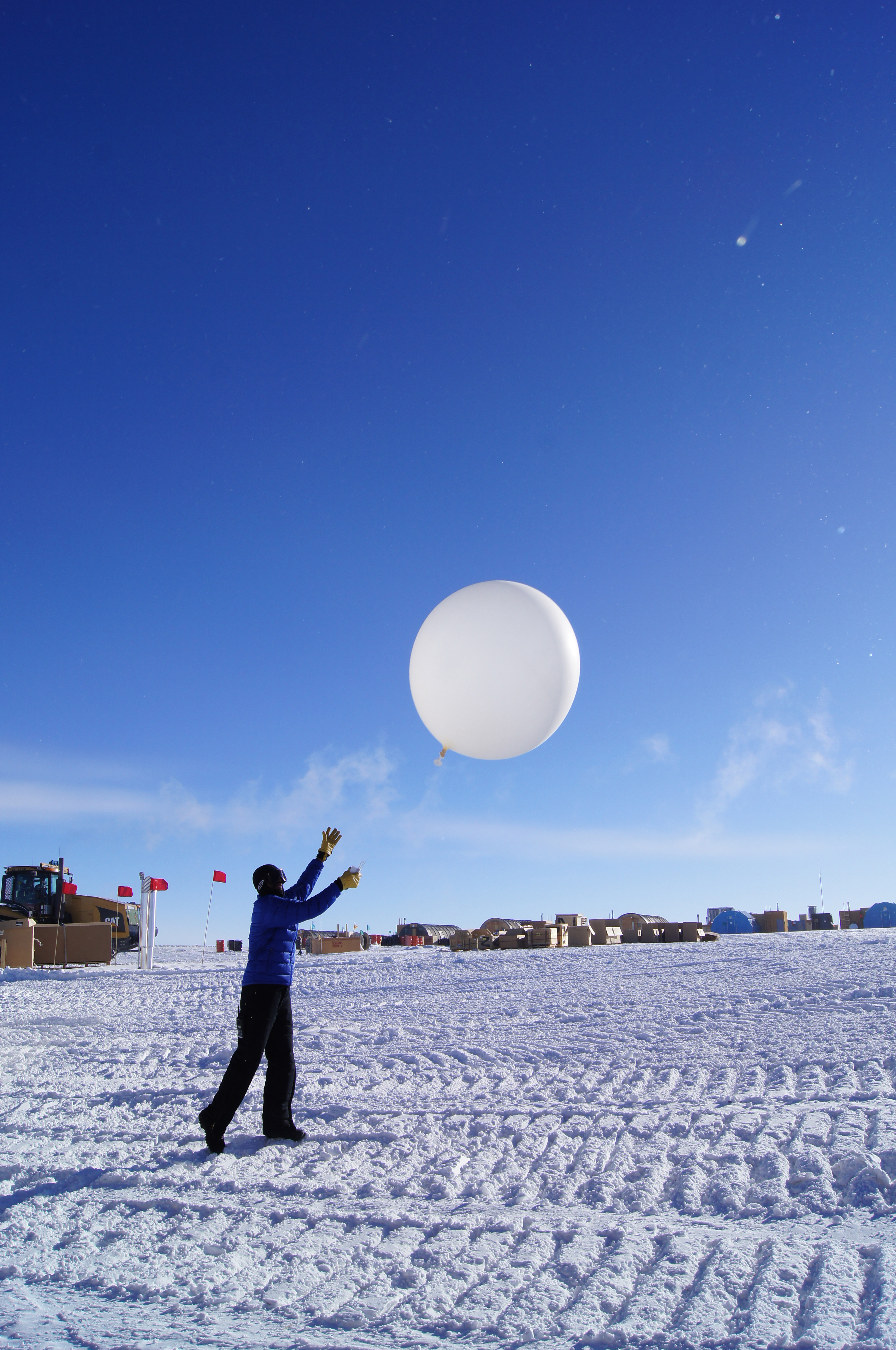 A person launches a balloon.