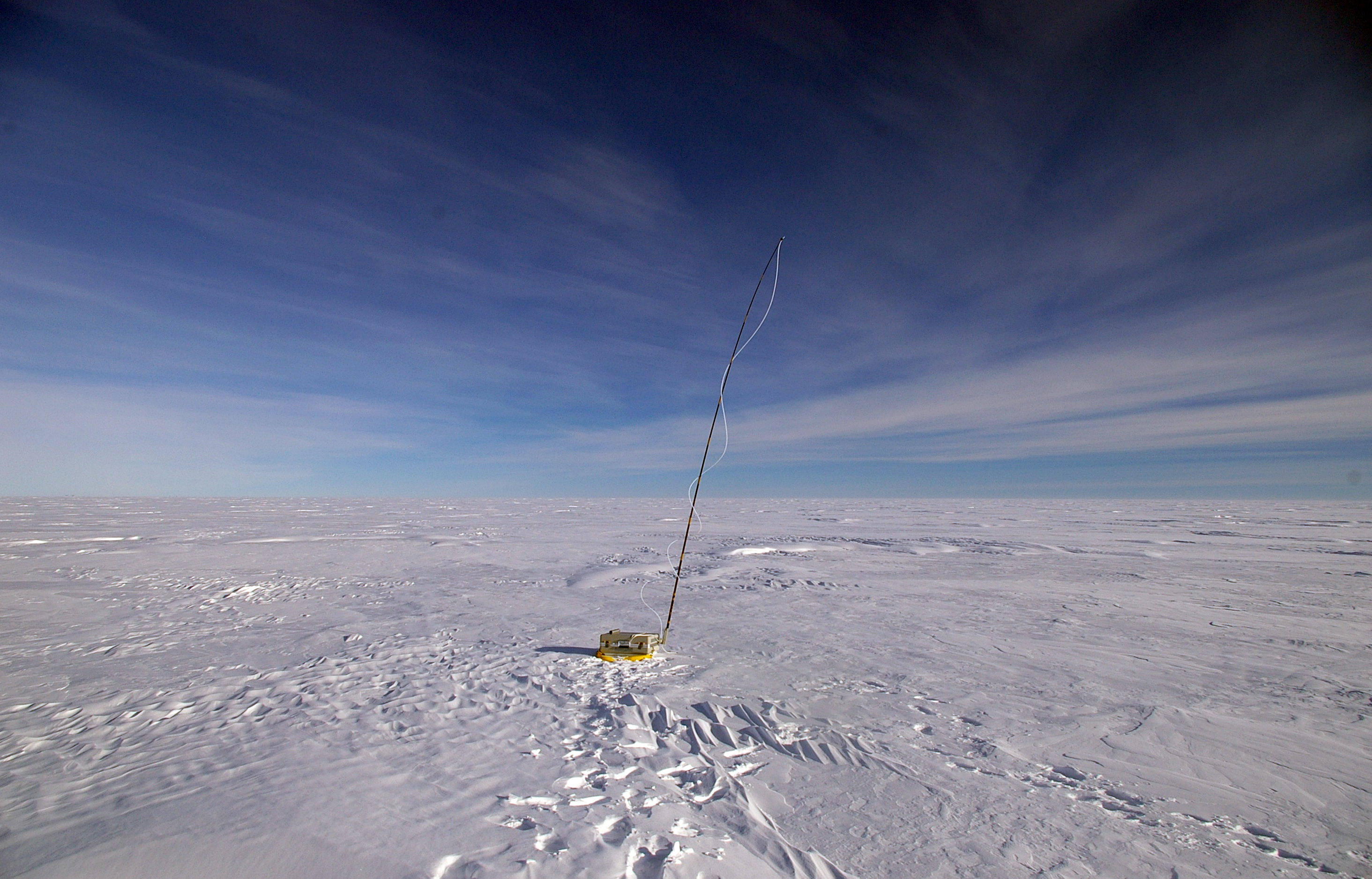An instrument with an antenna on a plain of snow.