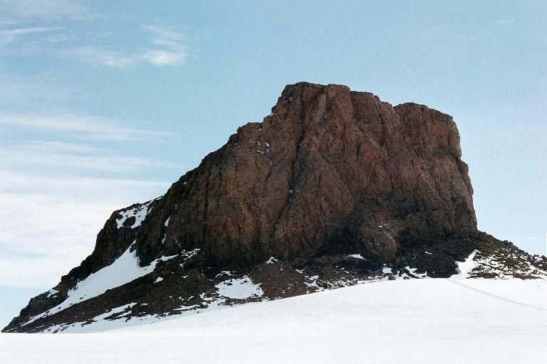 A large rock outcropping rises above the snow.