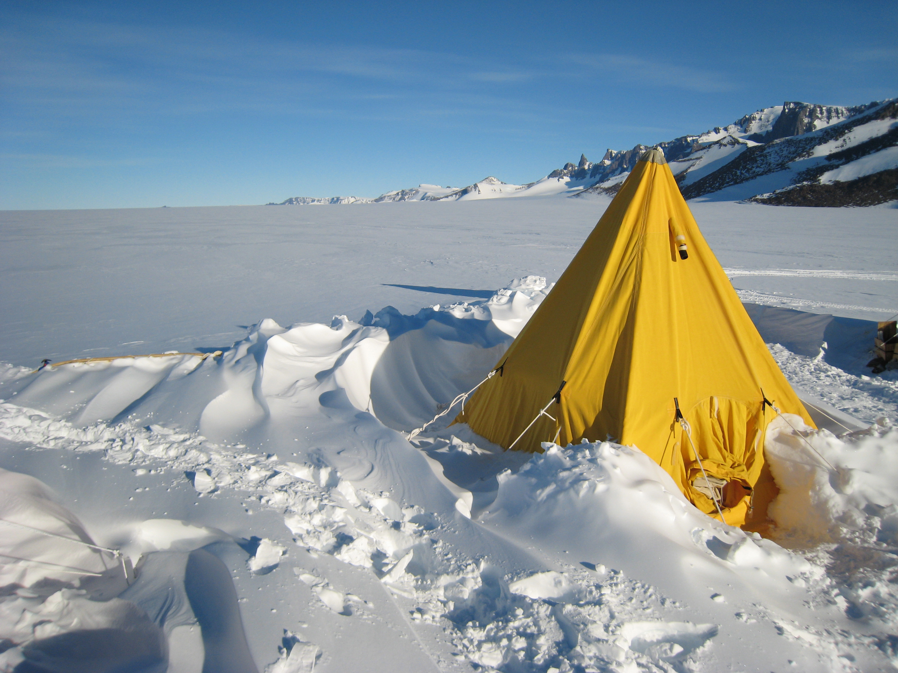 Yellow tent in snow.