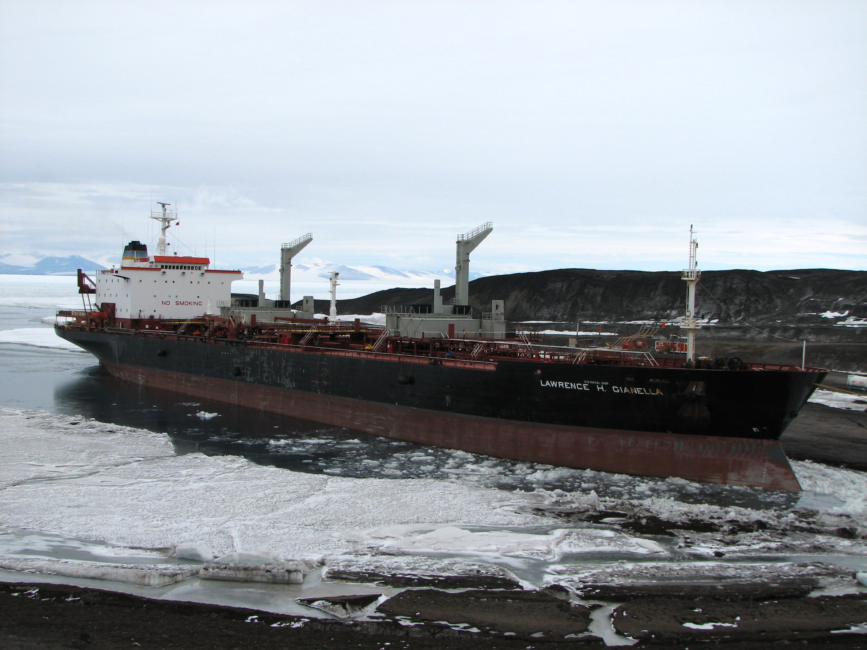 Ship moors in icy water.
