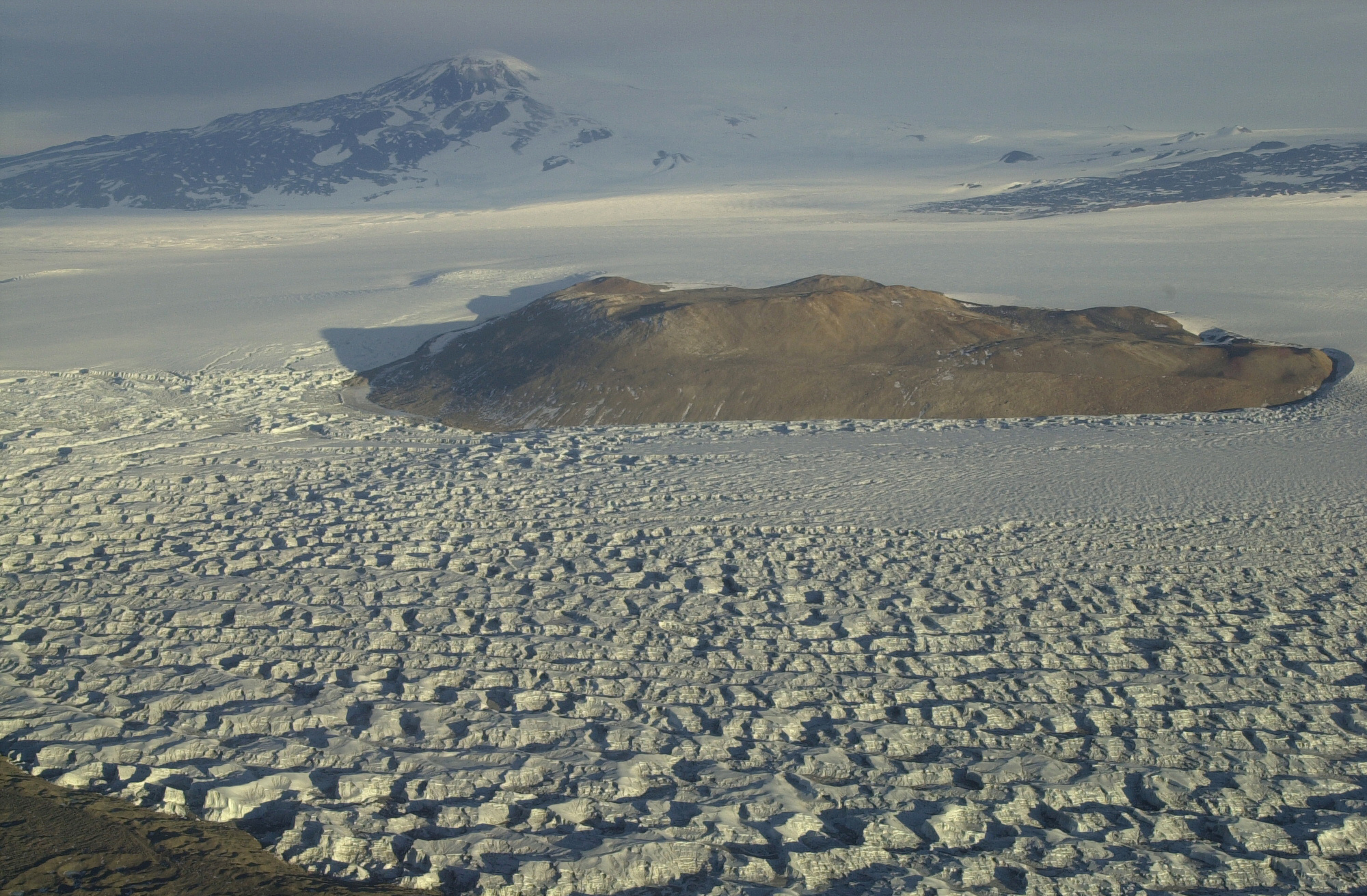 Aerial view of a glacier and mountains.