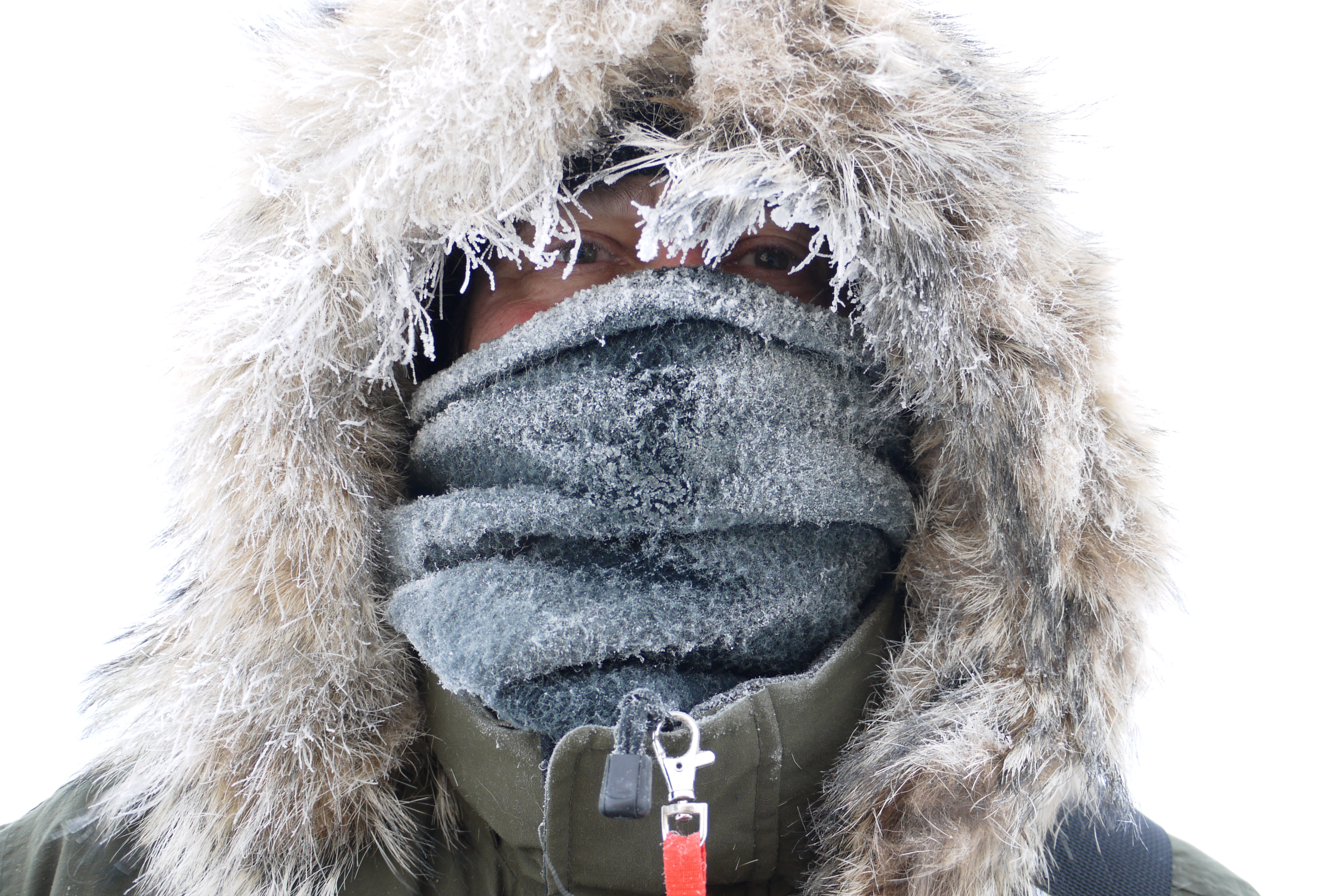 A person with frost covered face mask.