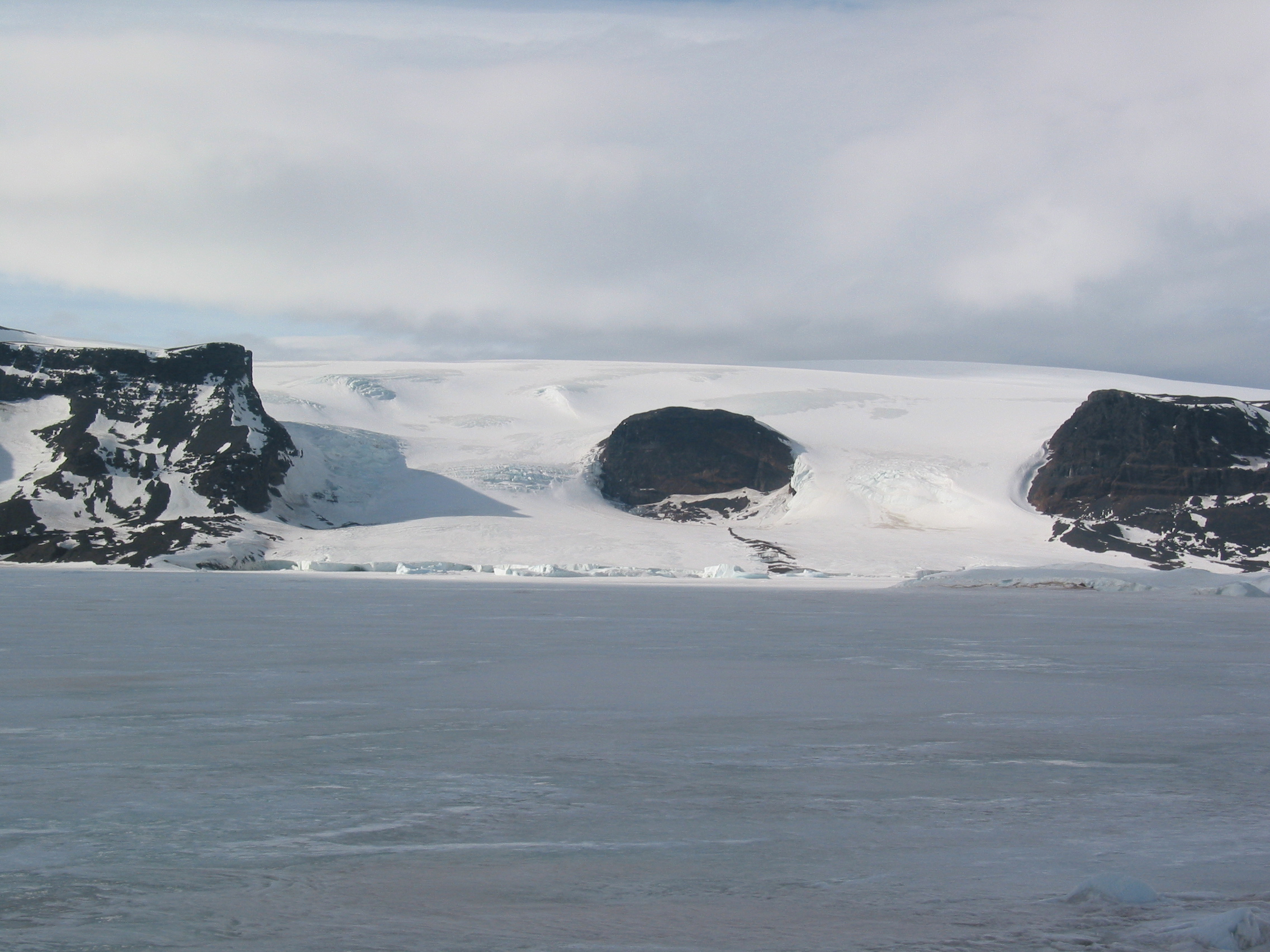 Glaciers flow into frozen sea ice.