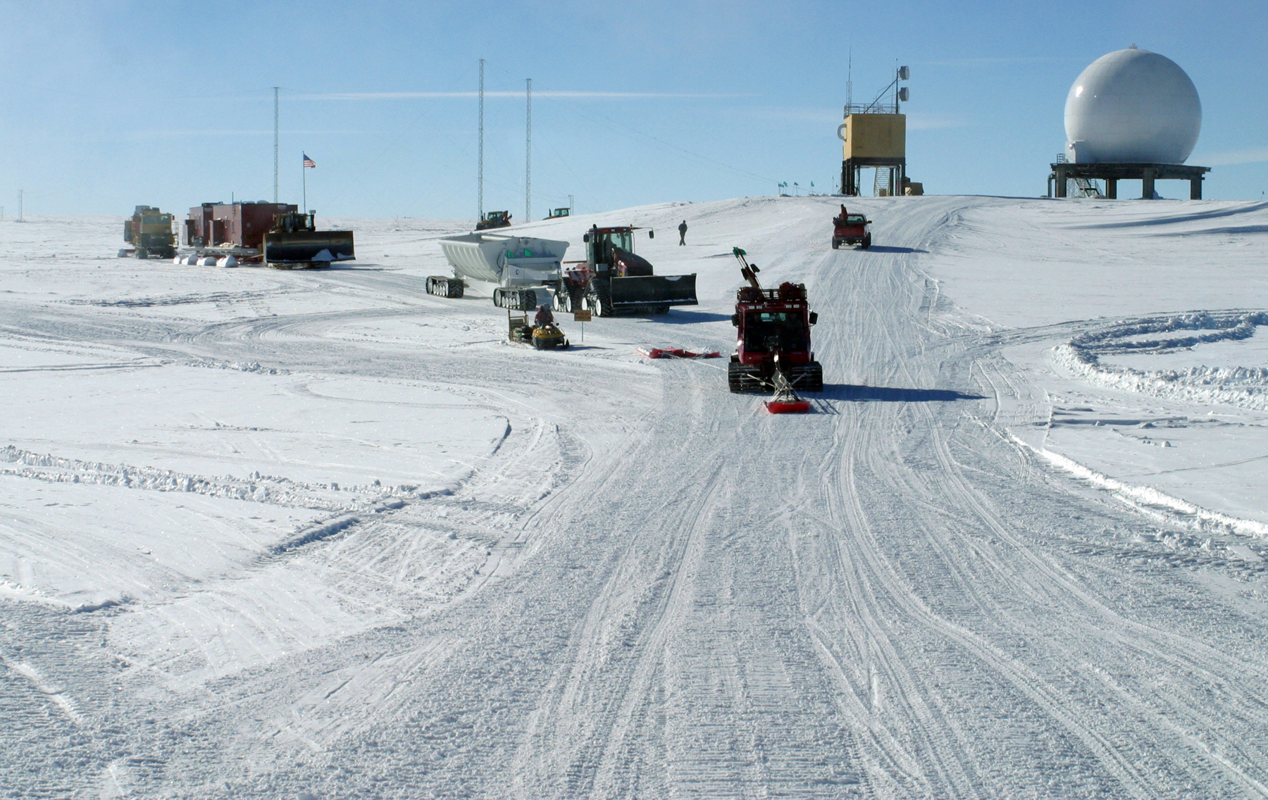 A snow route with several vehicles on it.