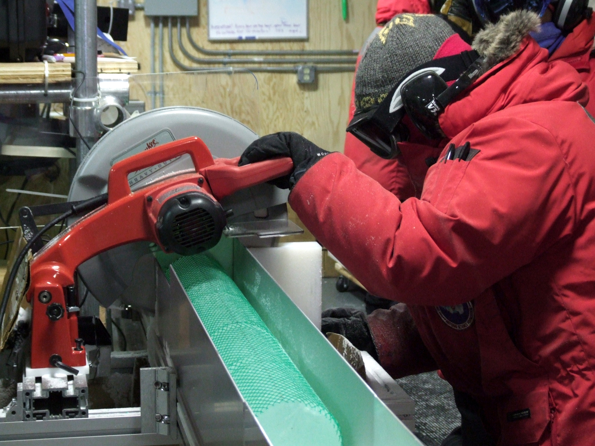 A person saws an ice core.