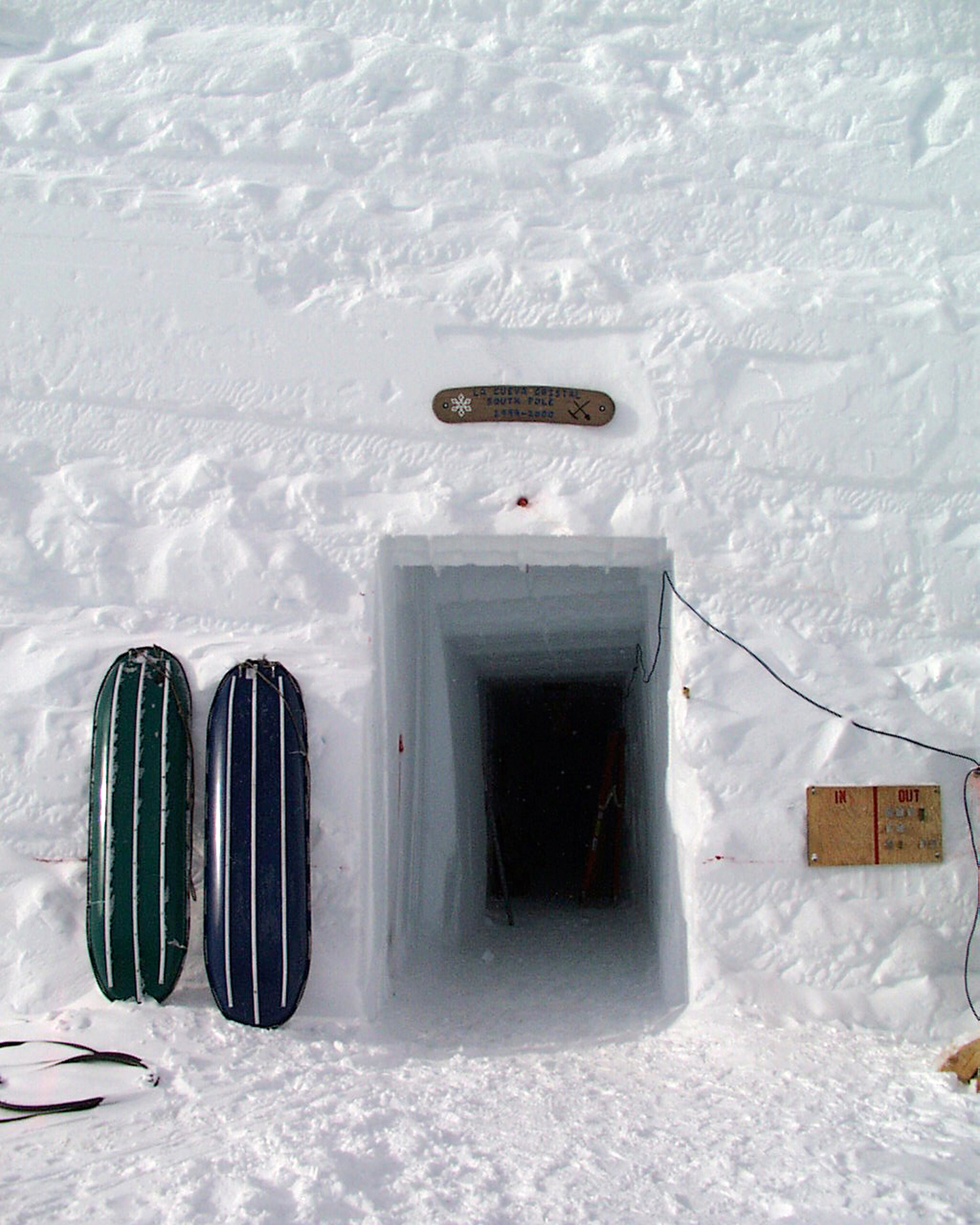 An entrance is cut into a solid wall of snow.