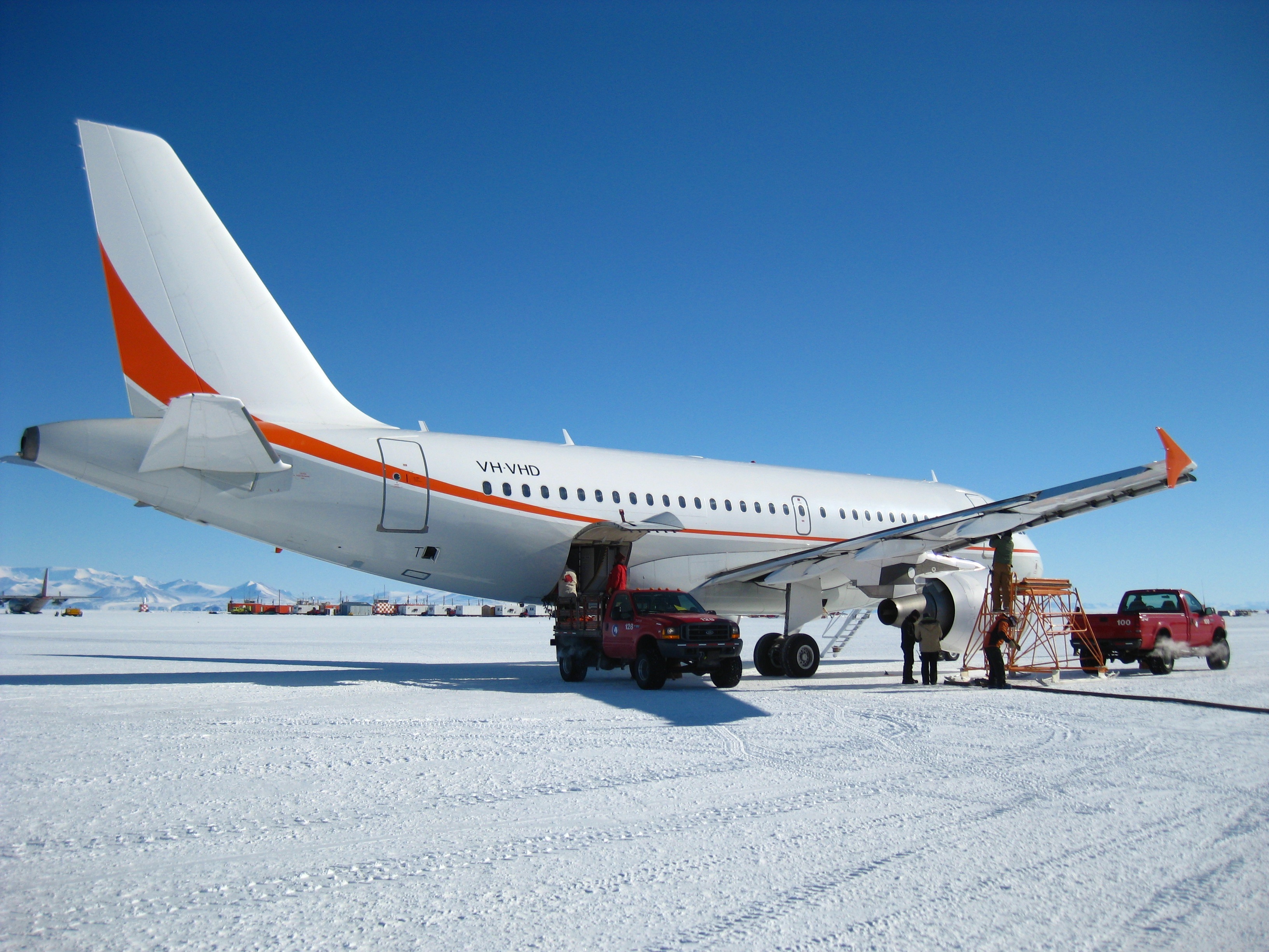 Plane sits on ice runway.
