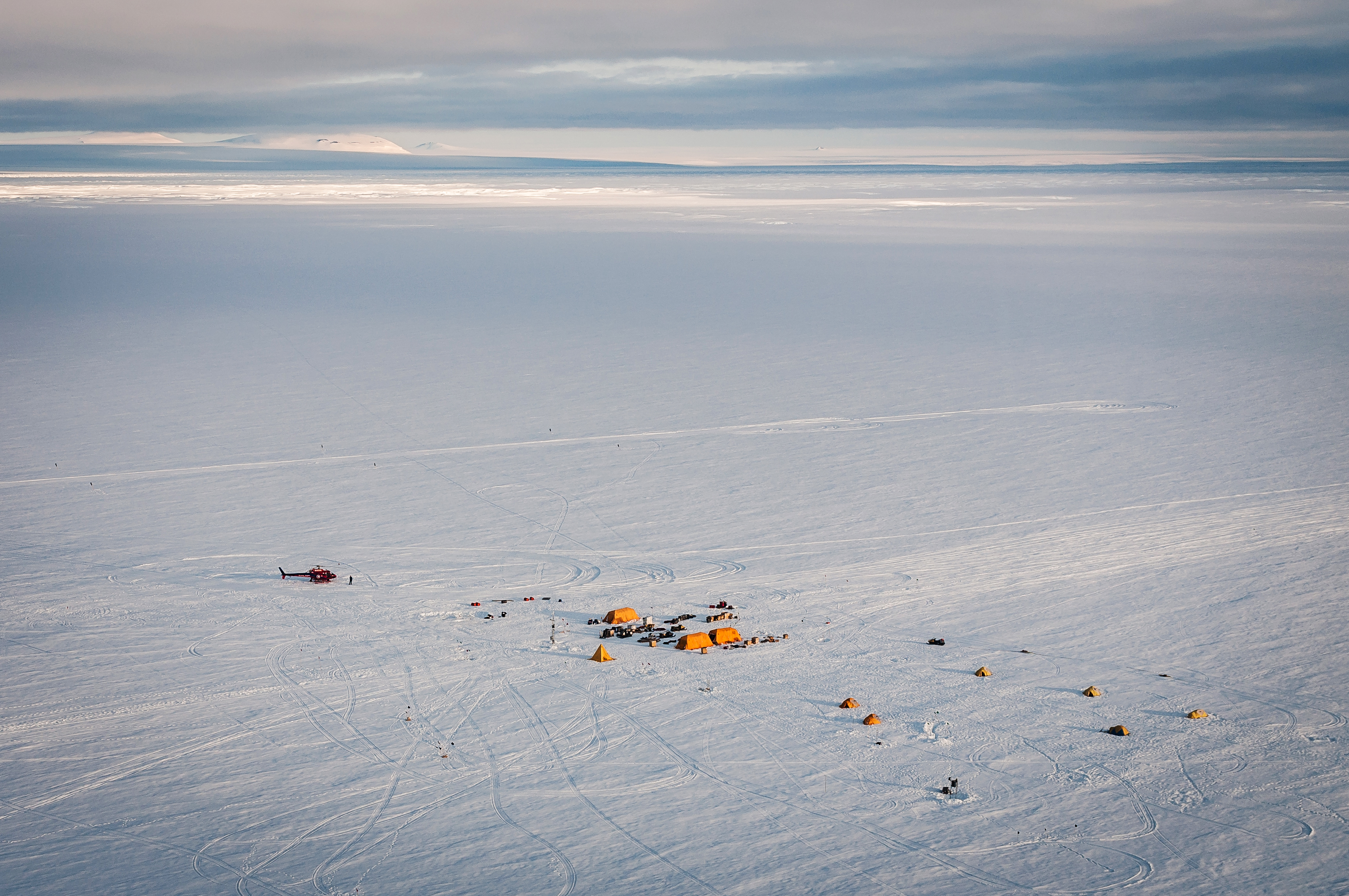 Aerial view of a field camp on snow.