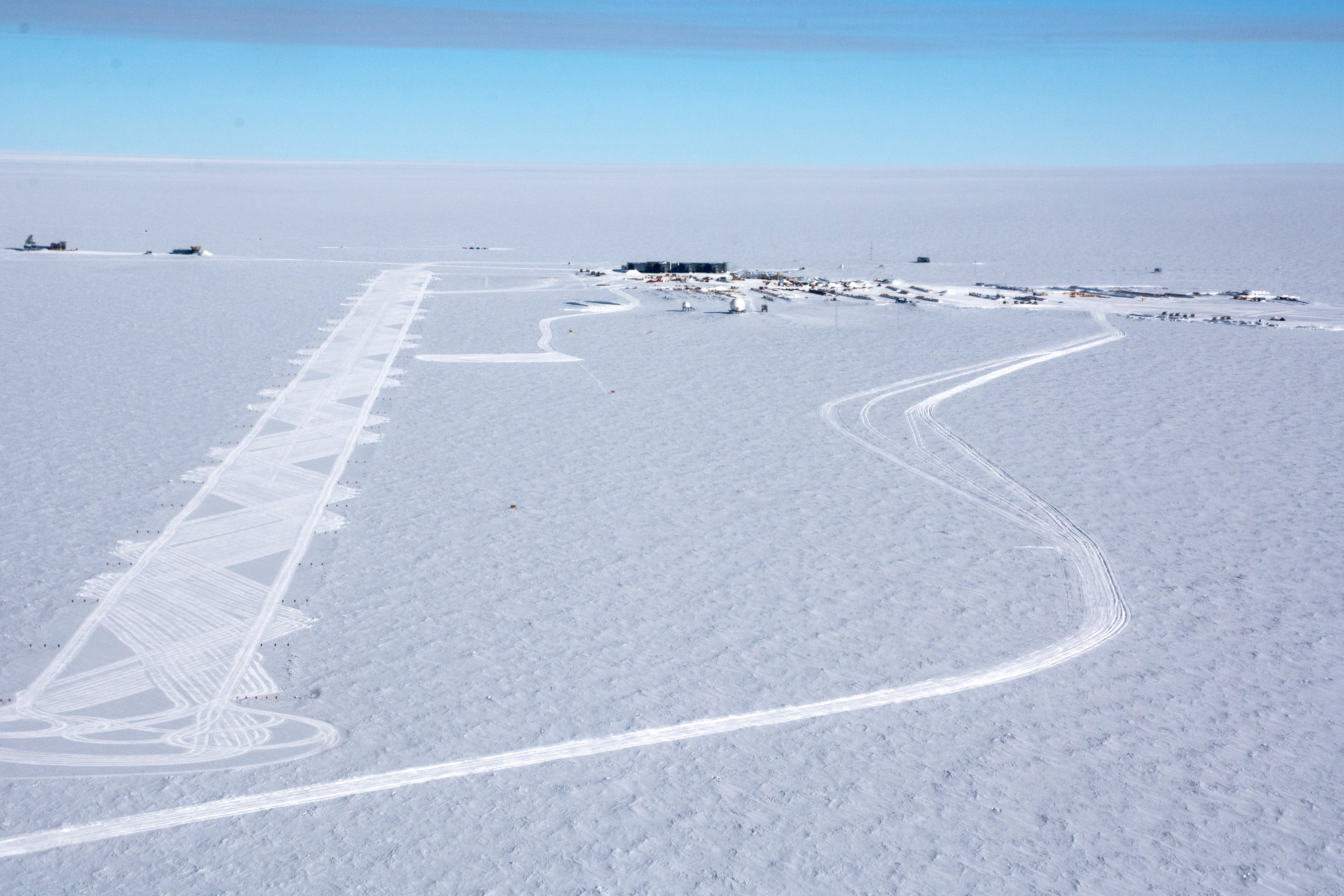 Aerial photos of buildings on a flat white snow surface.