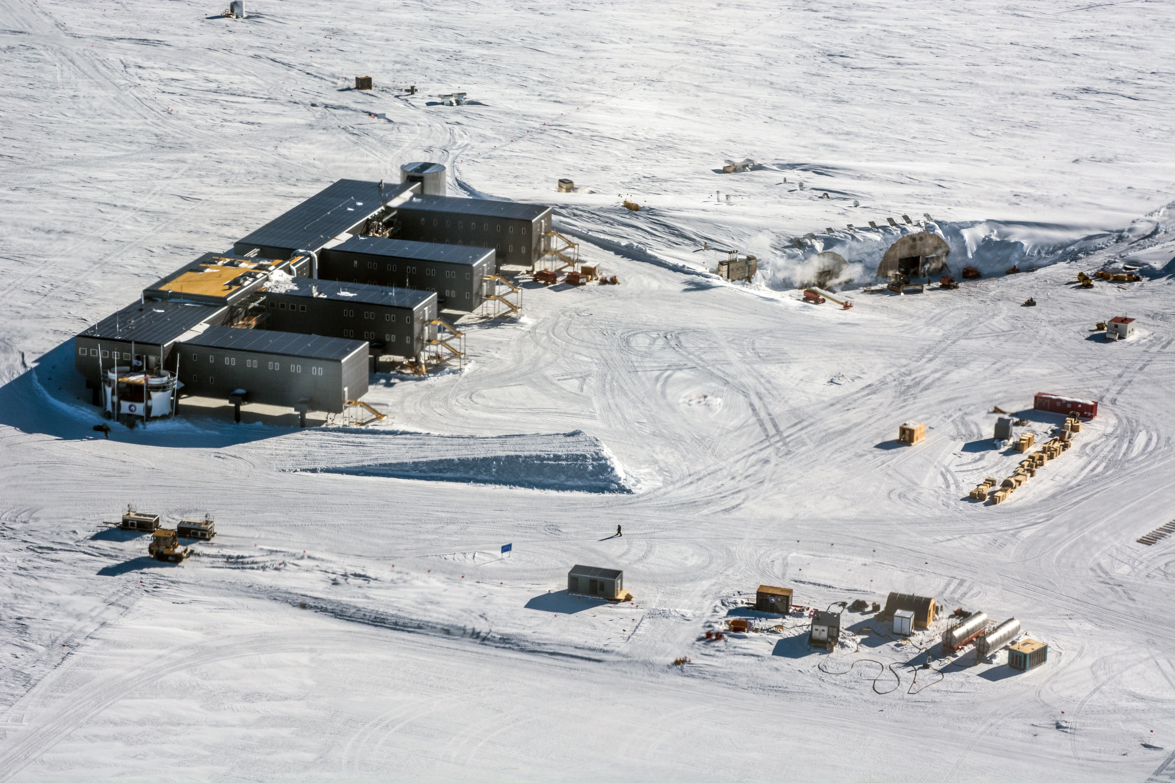 Aerial photos of buildings on a flat white snow surface.