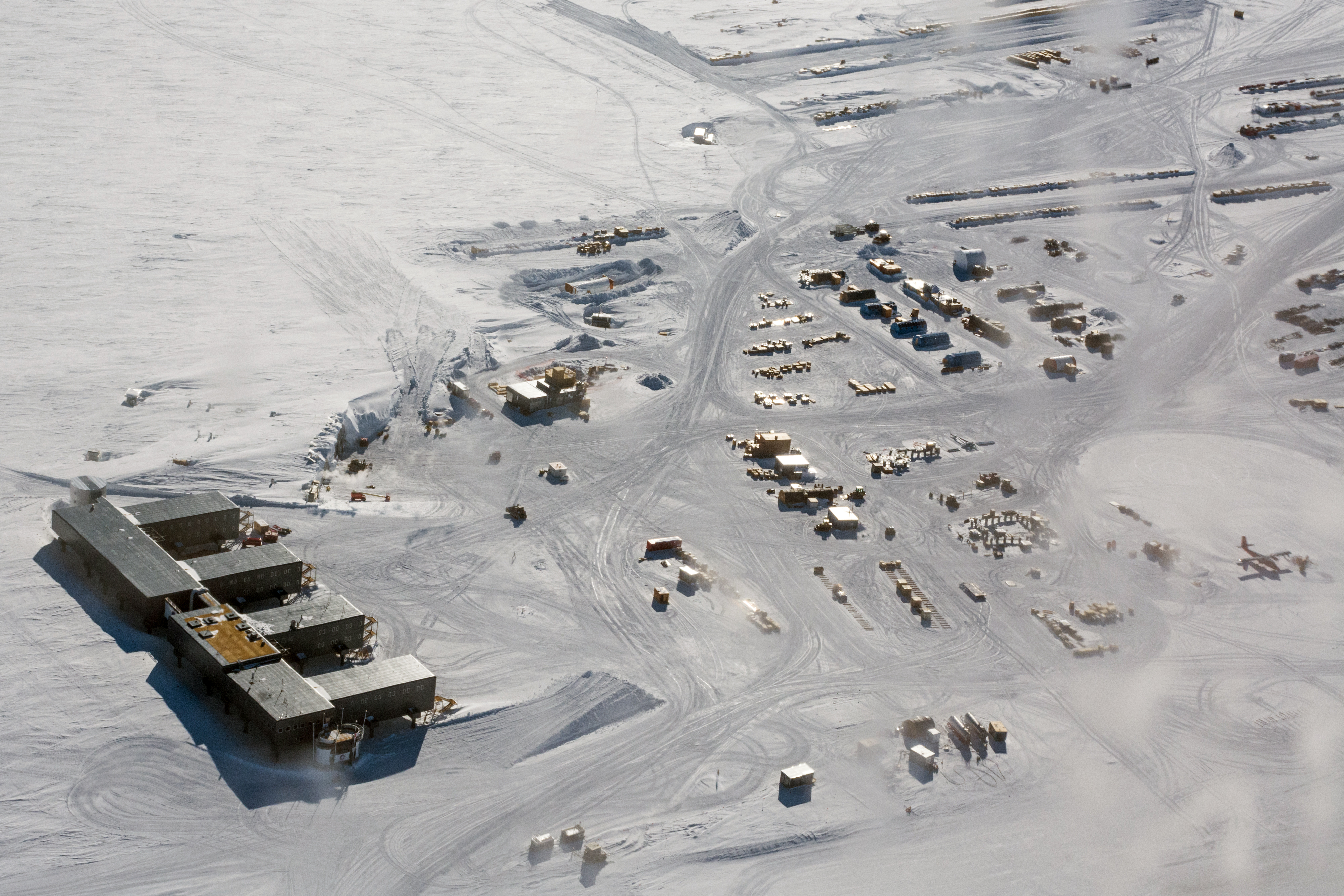 Aerial photos of buildings on a flat white snow surface.