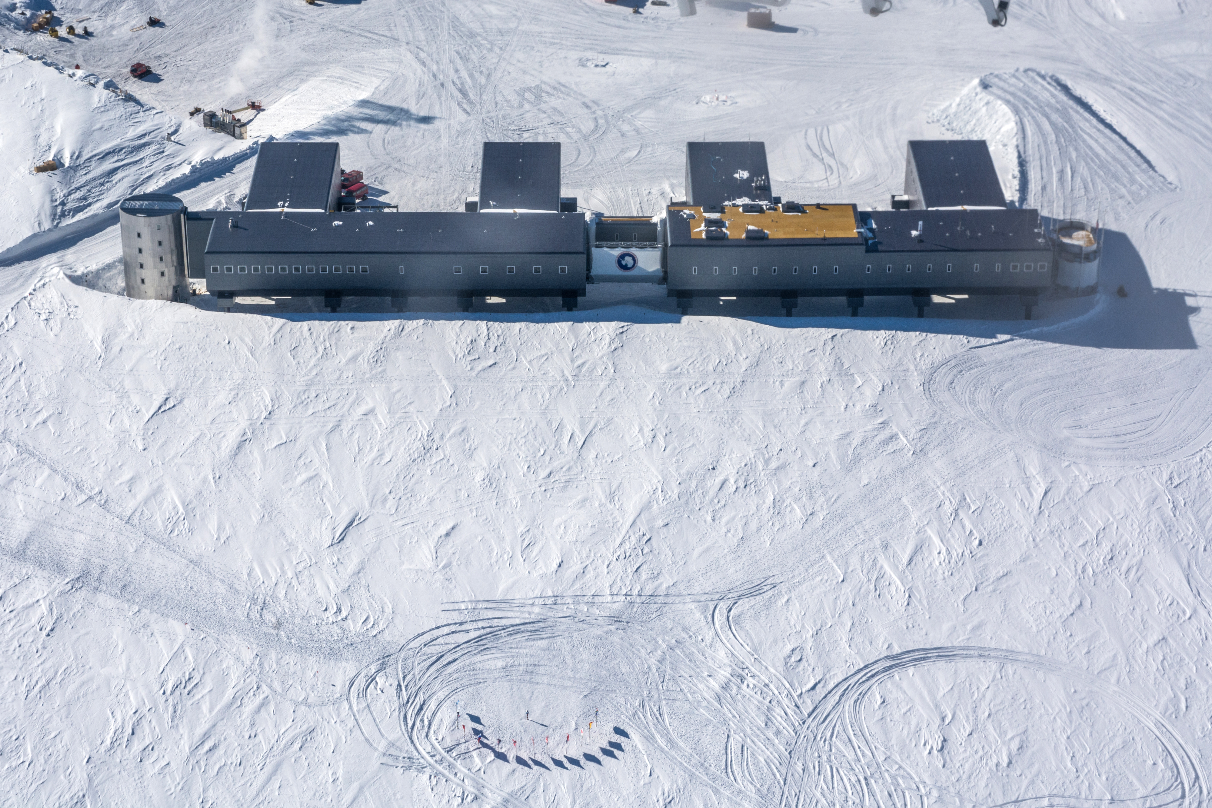 Aerial photos of buildings on a flat white snow surface.