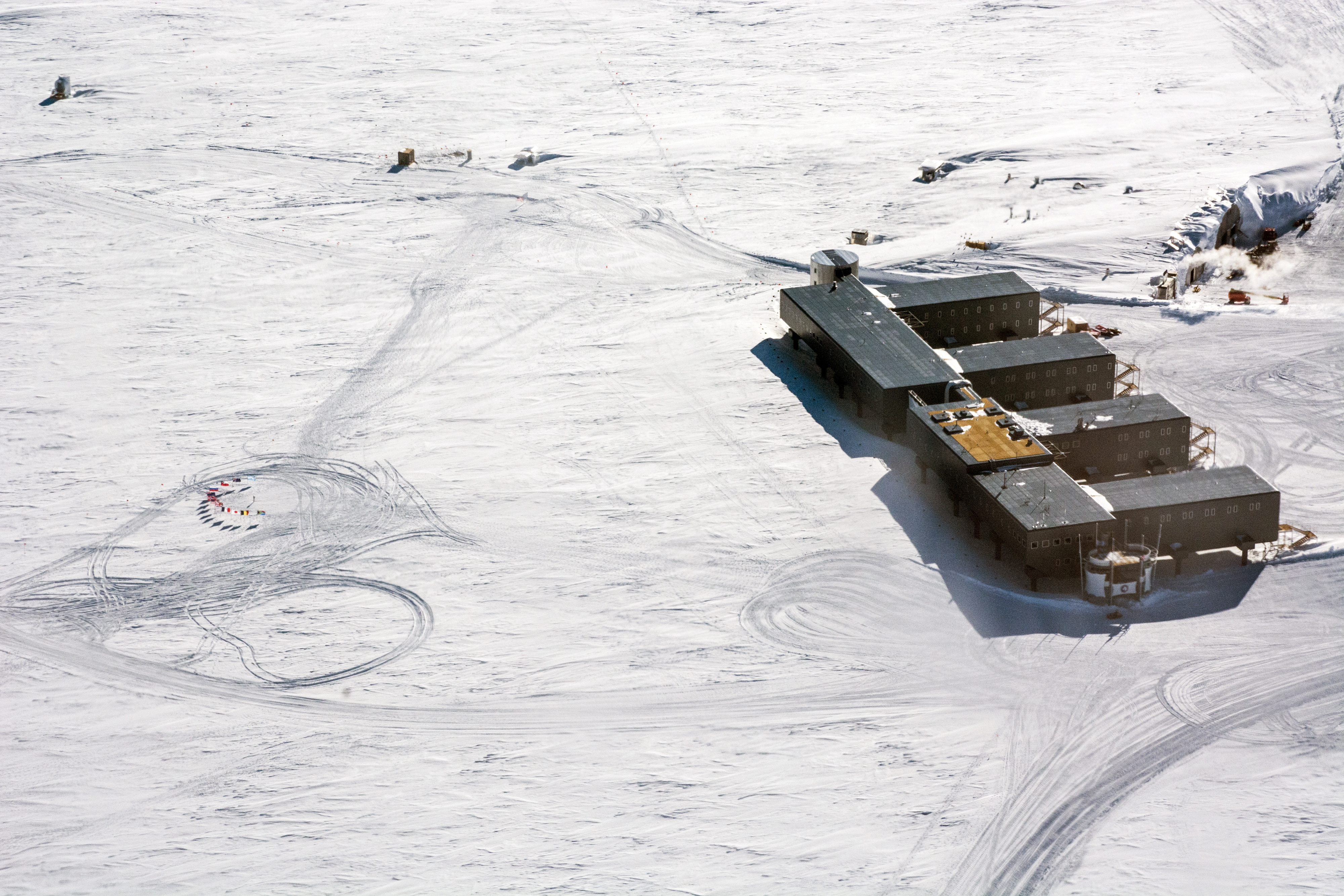 Aerial photos of buildings on a flat white snow surface.