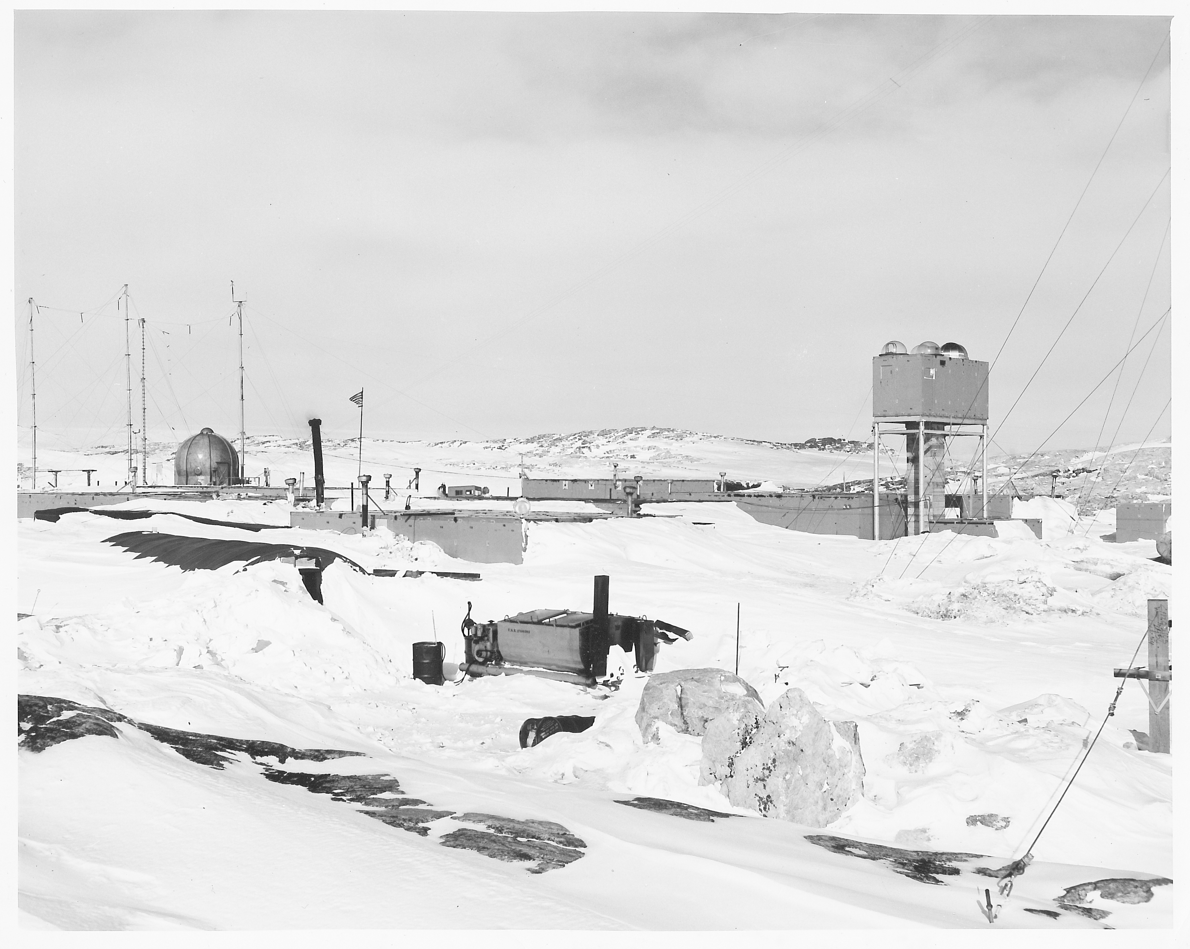 Several building structures surrounded by snow.