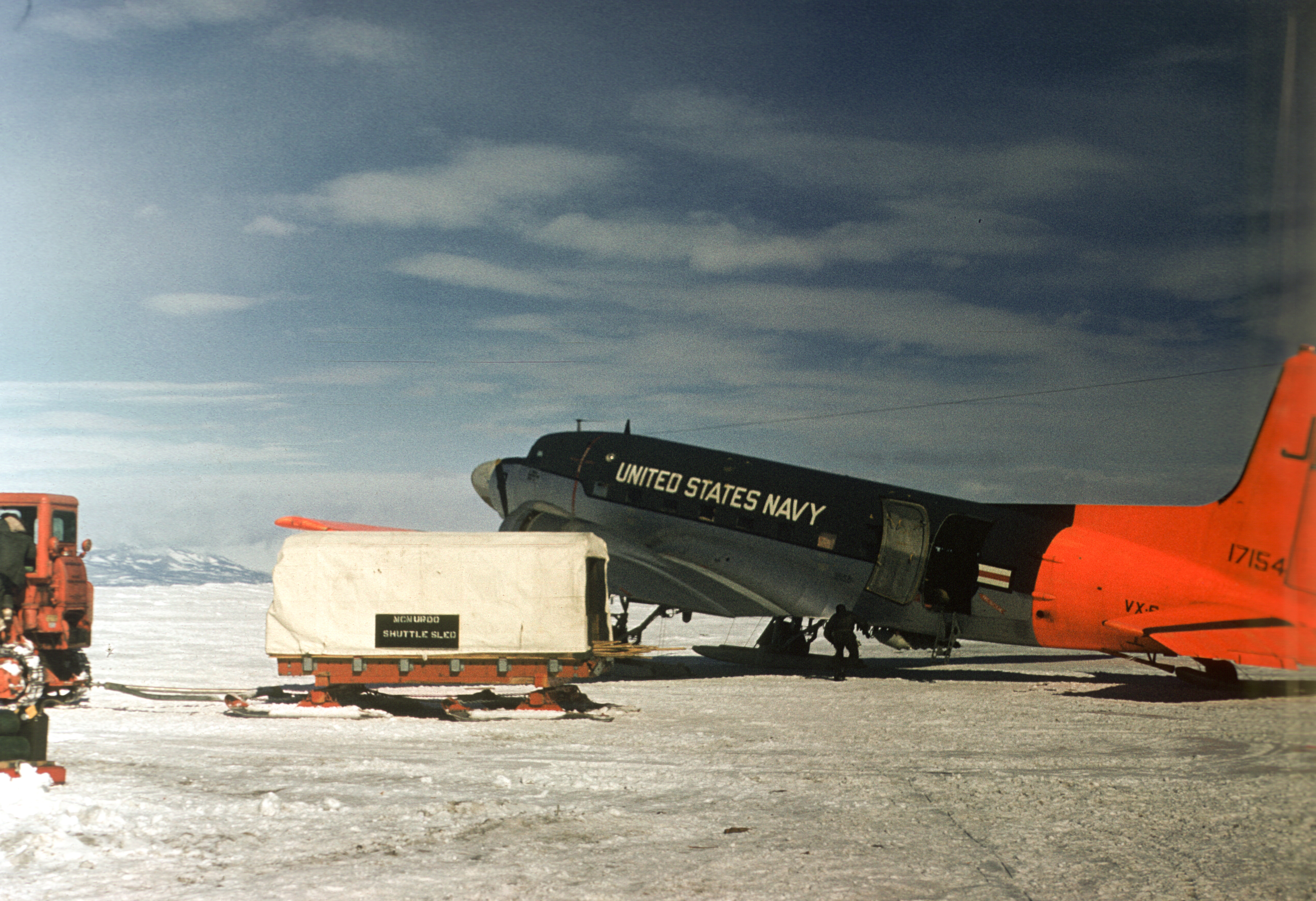 A U.S. Navy airplane sitting on ice.