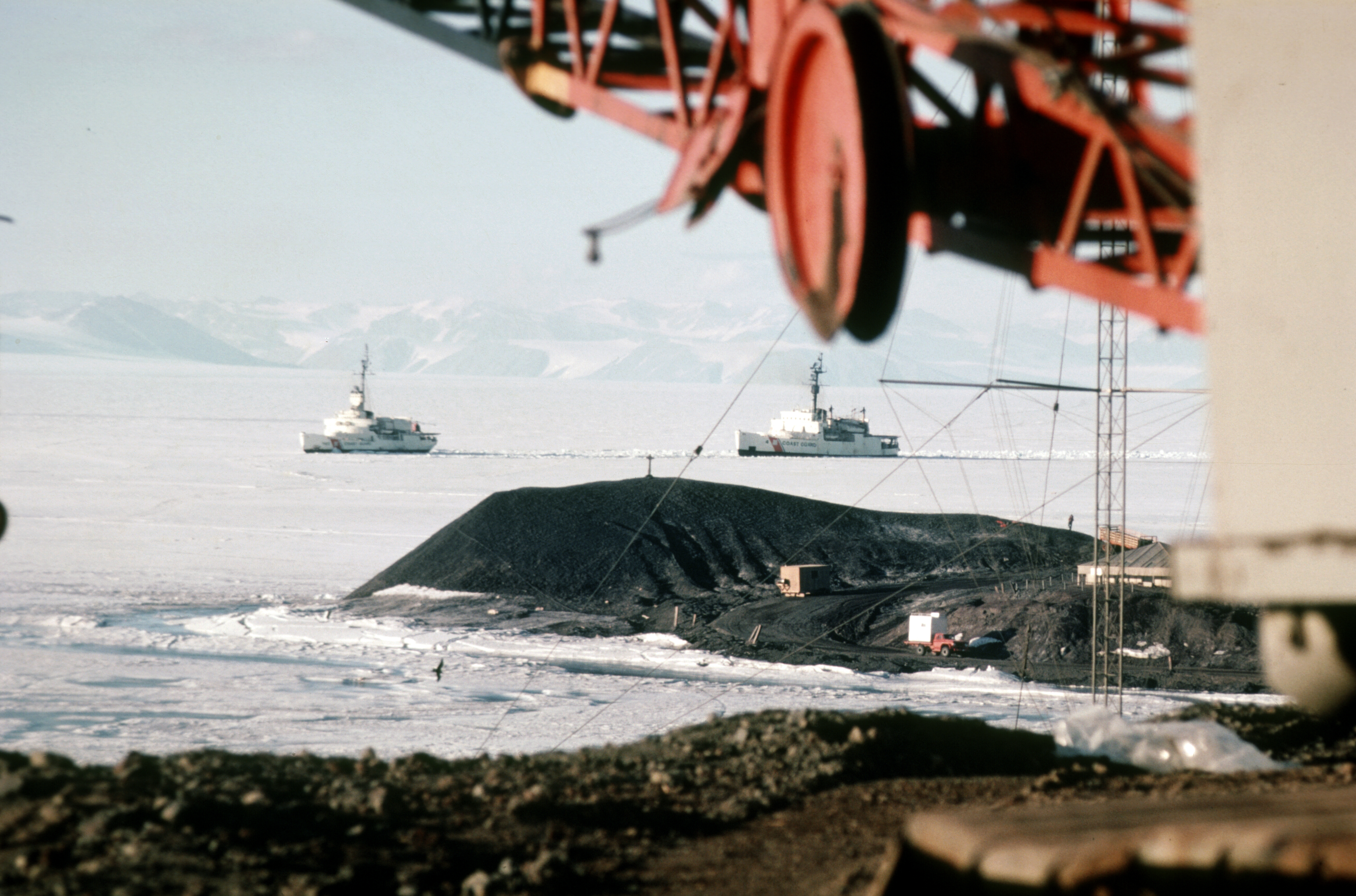 Two U.S. Coast Guard ships breaking through the ice.