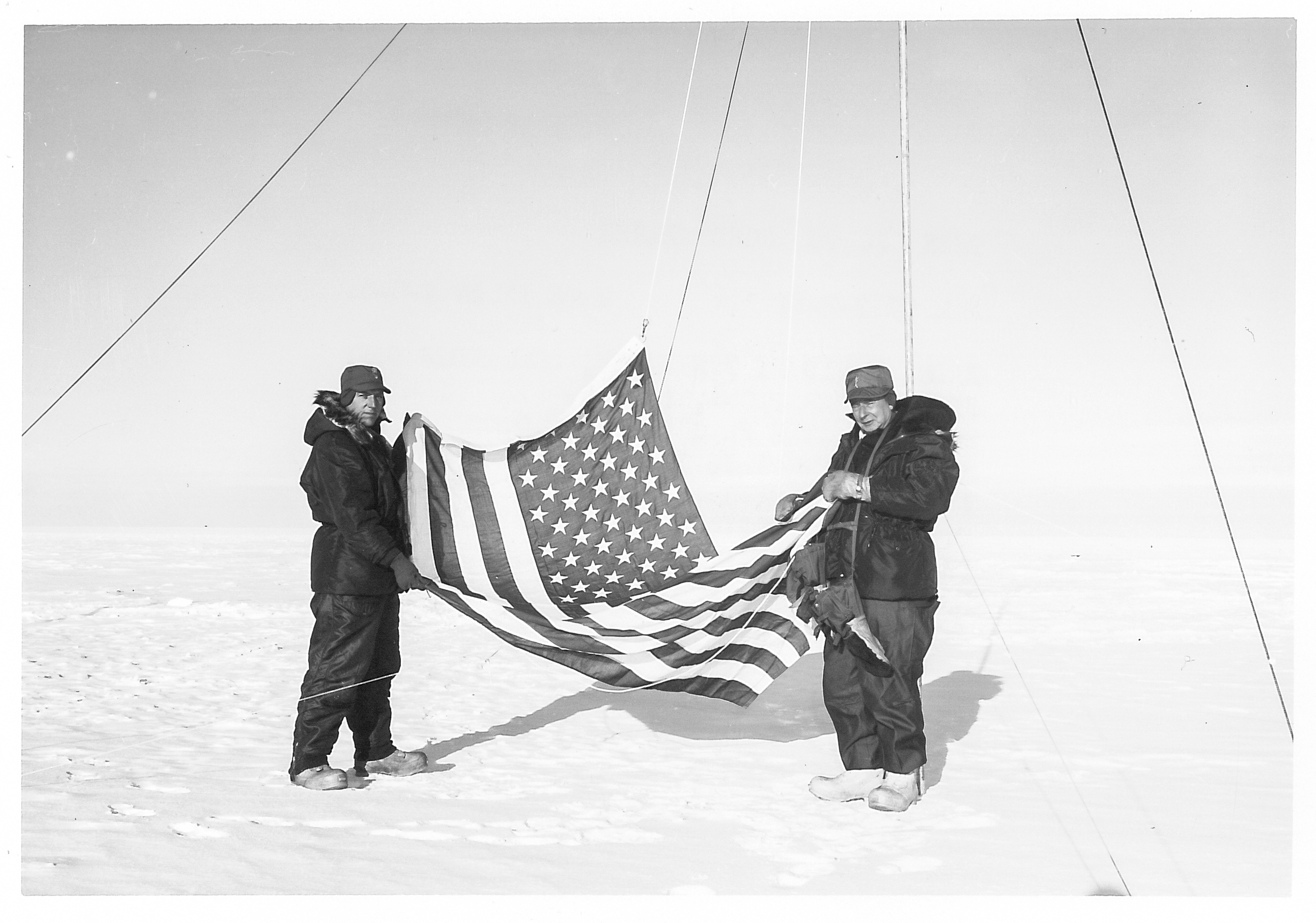 Two men holding an American flag.