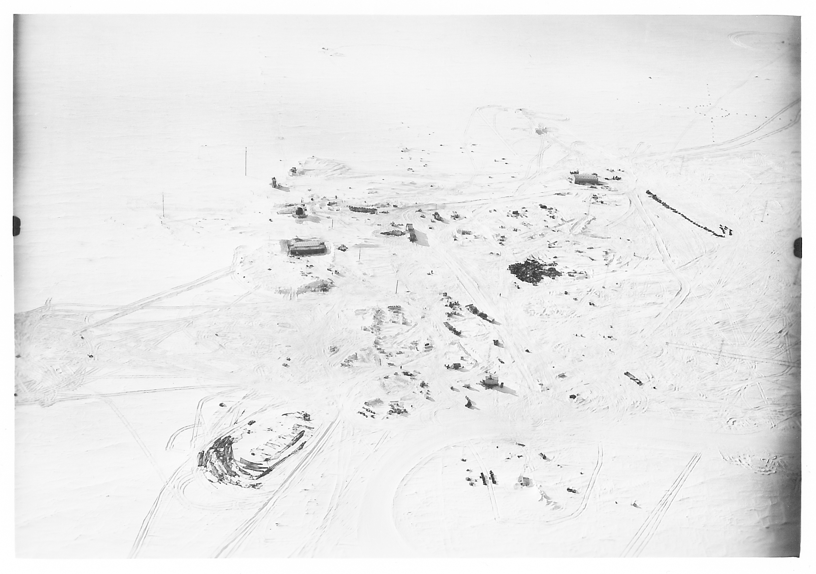 An aerial view of buildings on a frozen landscape.