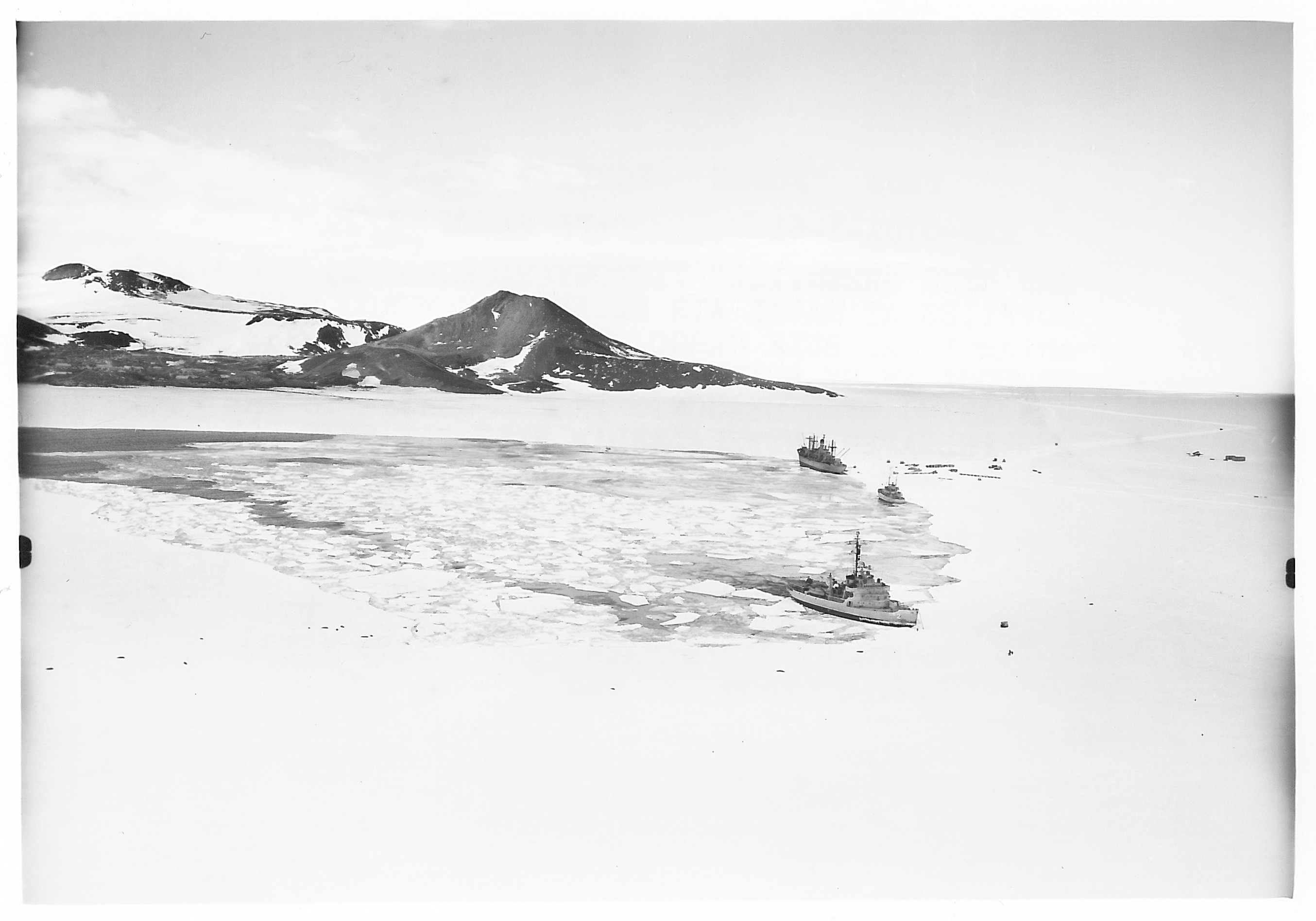 Three ships in ice-covered water.