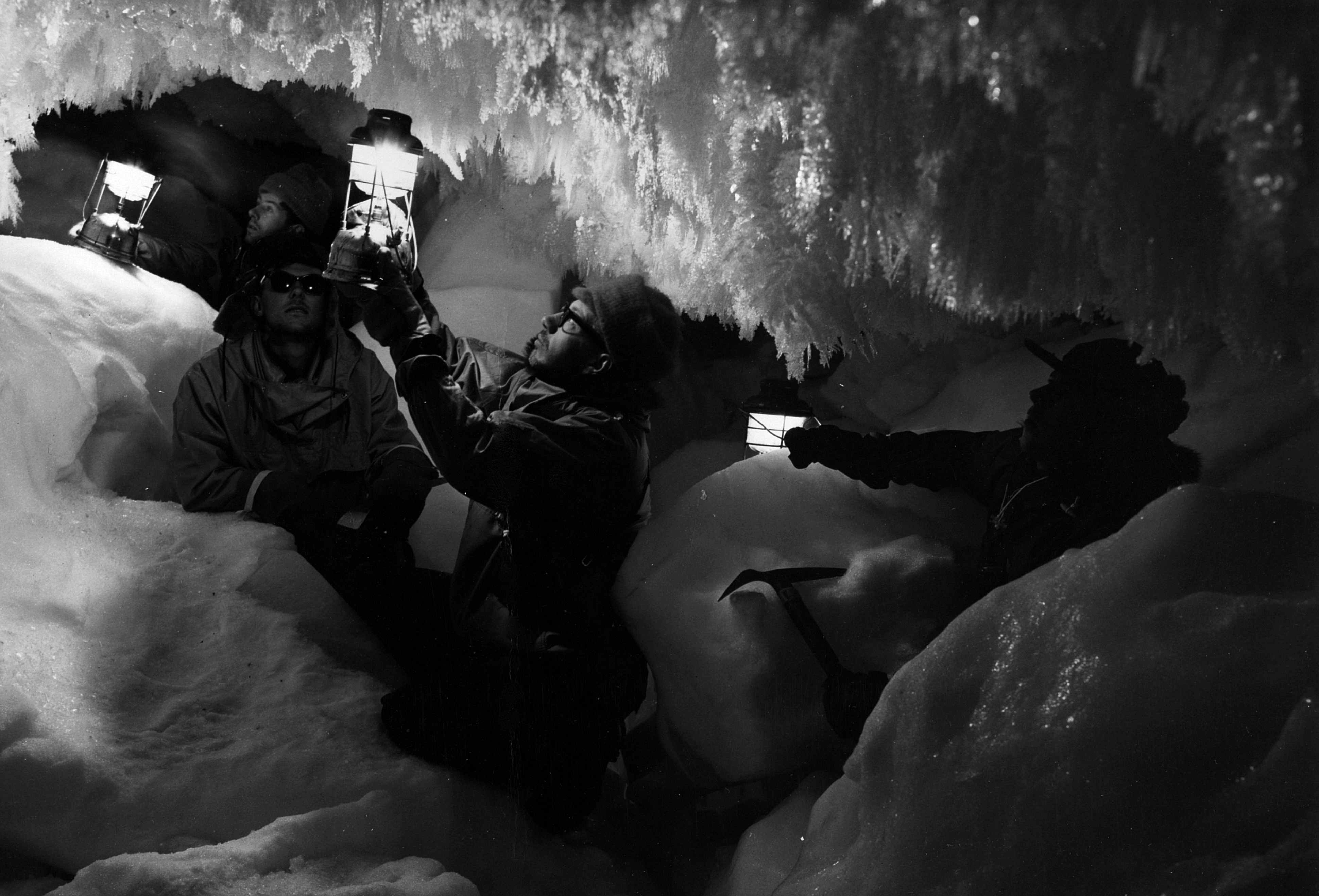 A group of men inside an ice cave.