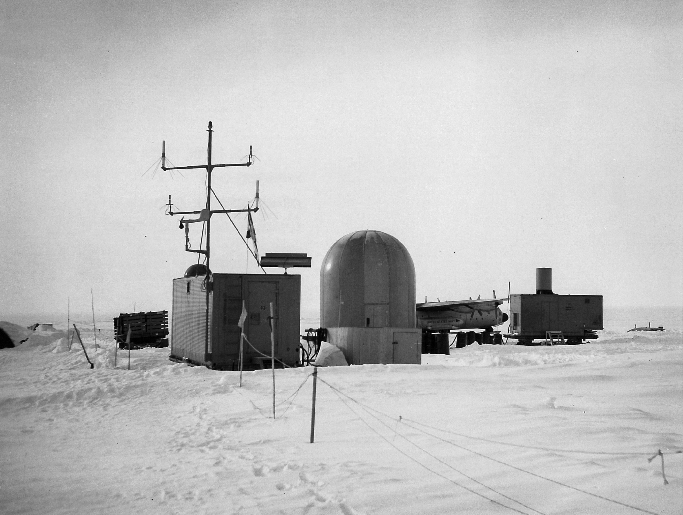 Small buildings on snow-covered ground.