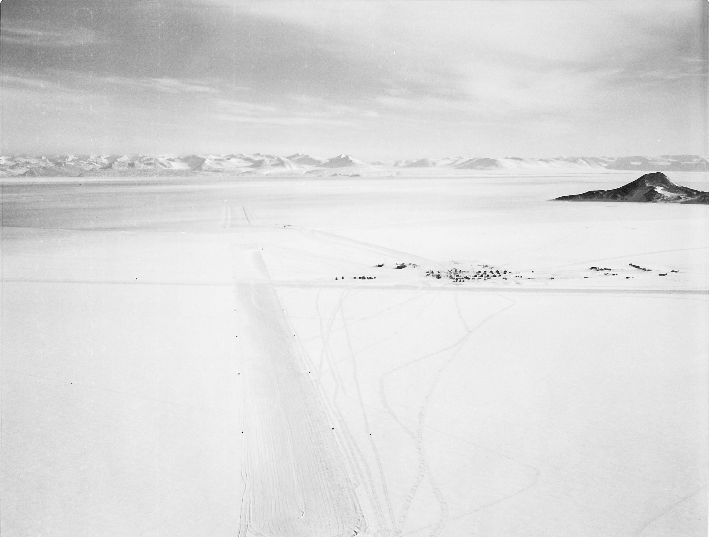 A frozen runway in a snowy landscape.