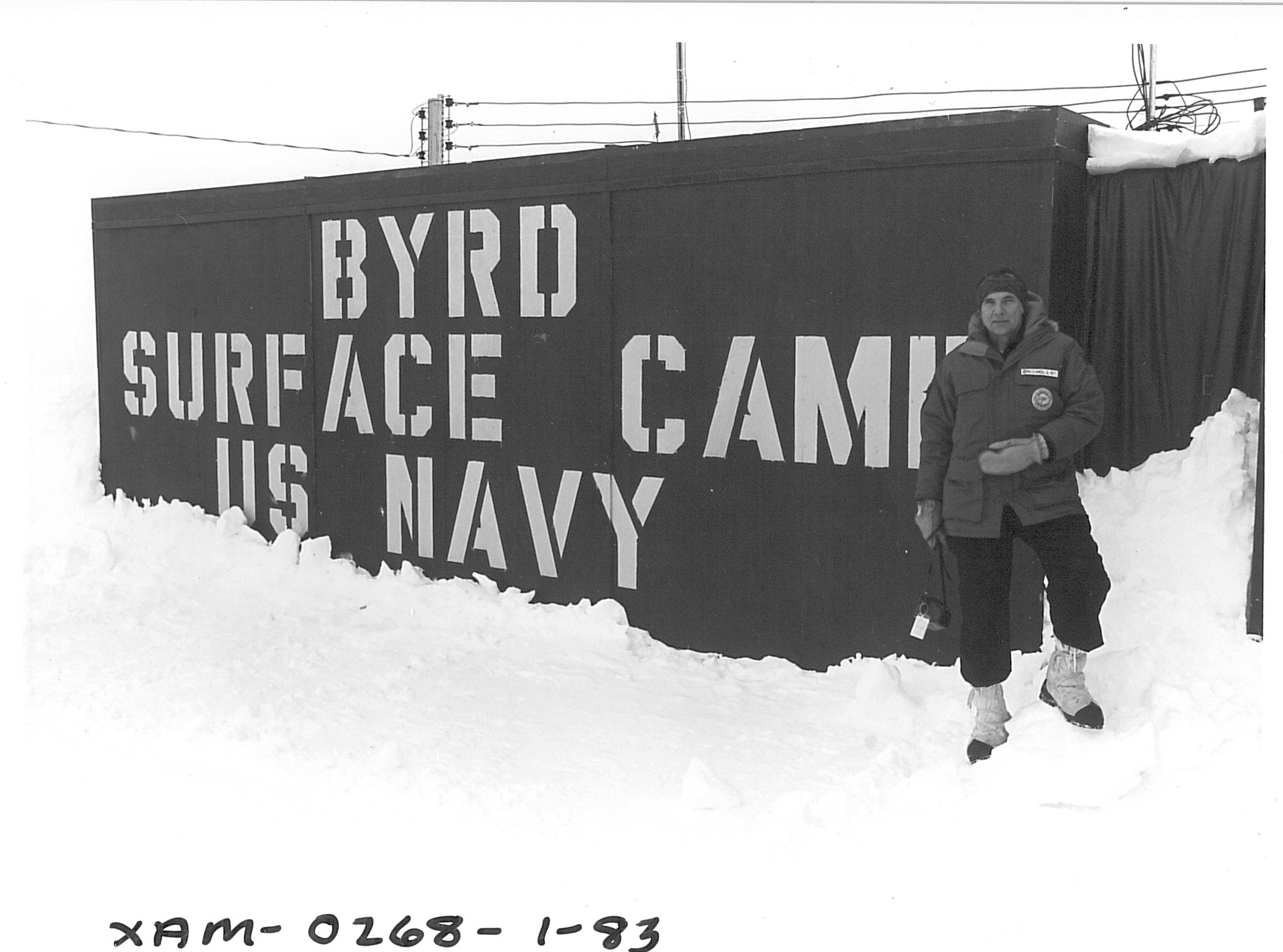 A large sign with a man standing next to it.