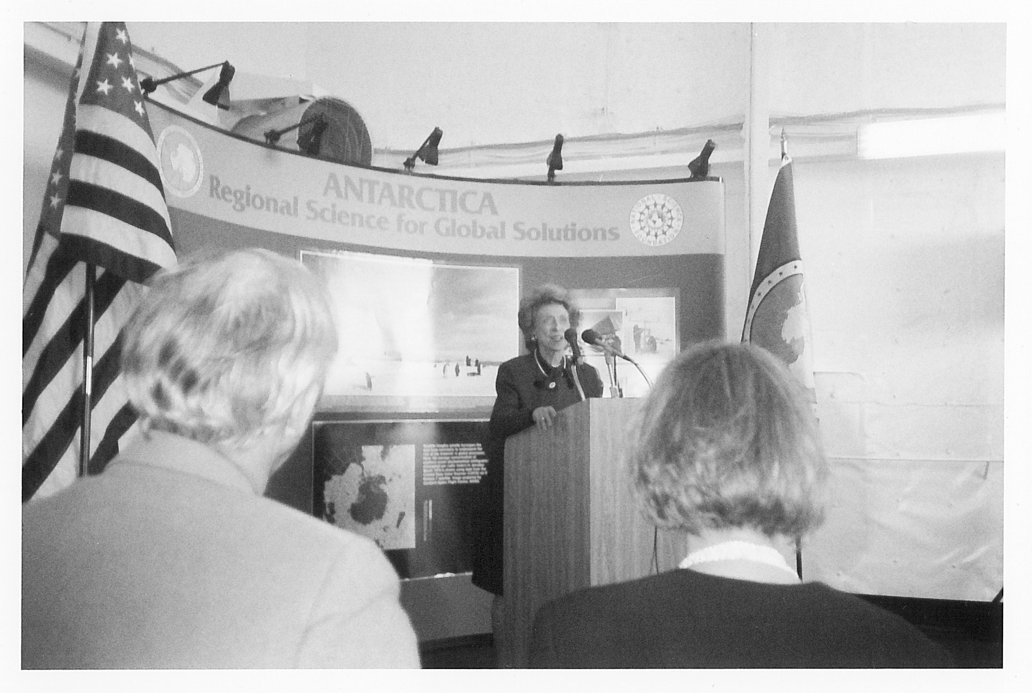 A woman standing behind a podium.