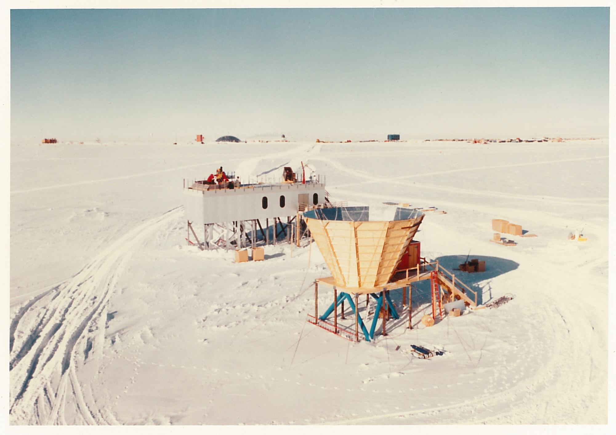 An aerial view of two elevated structures in the snow.