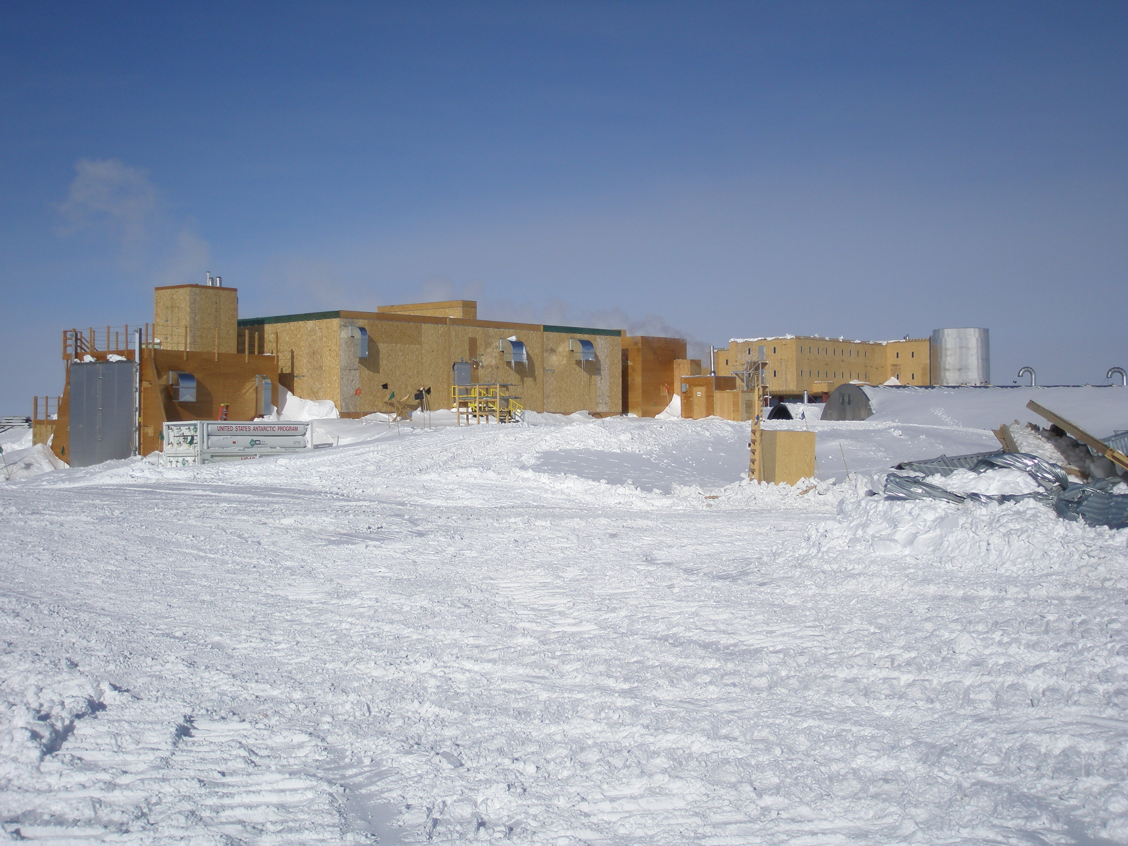 Buildings under construction on a snowy landscape.