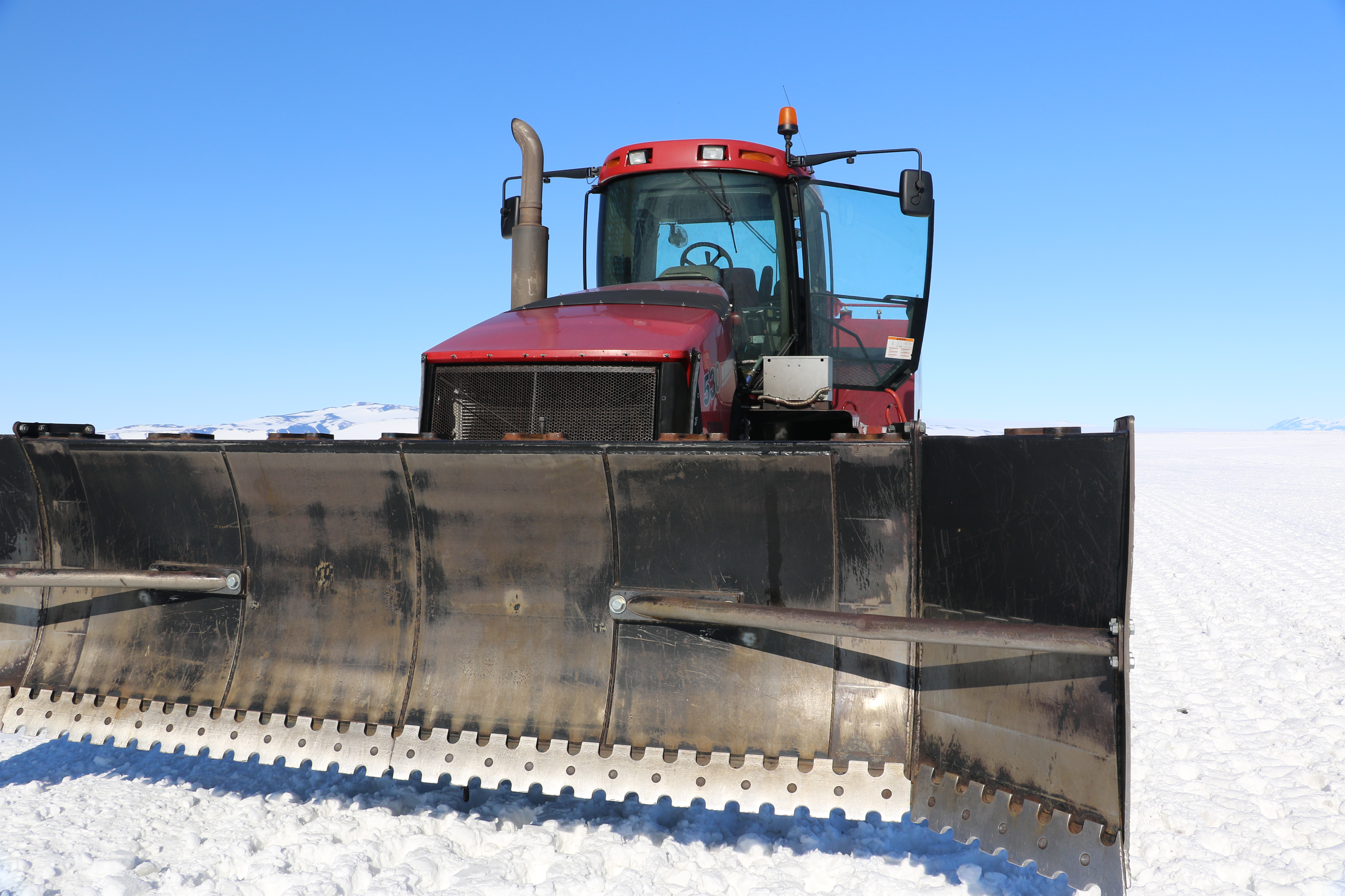 A tractor with a large front blade.