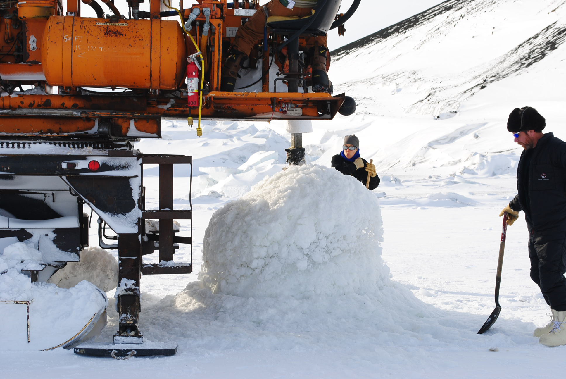 A large drill making a hole in the ice.