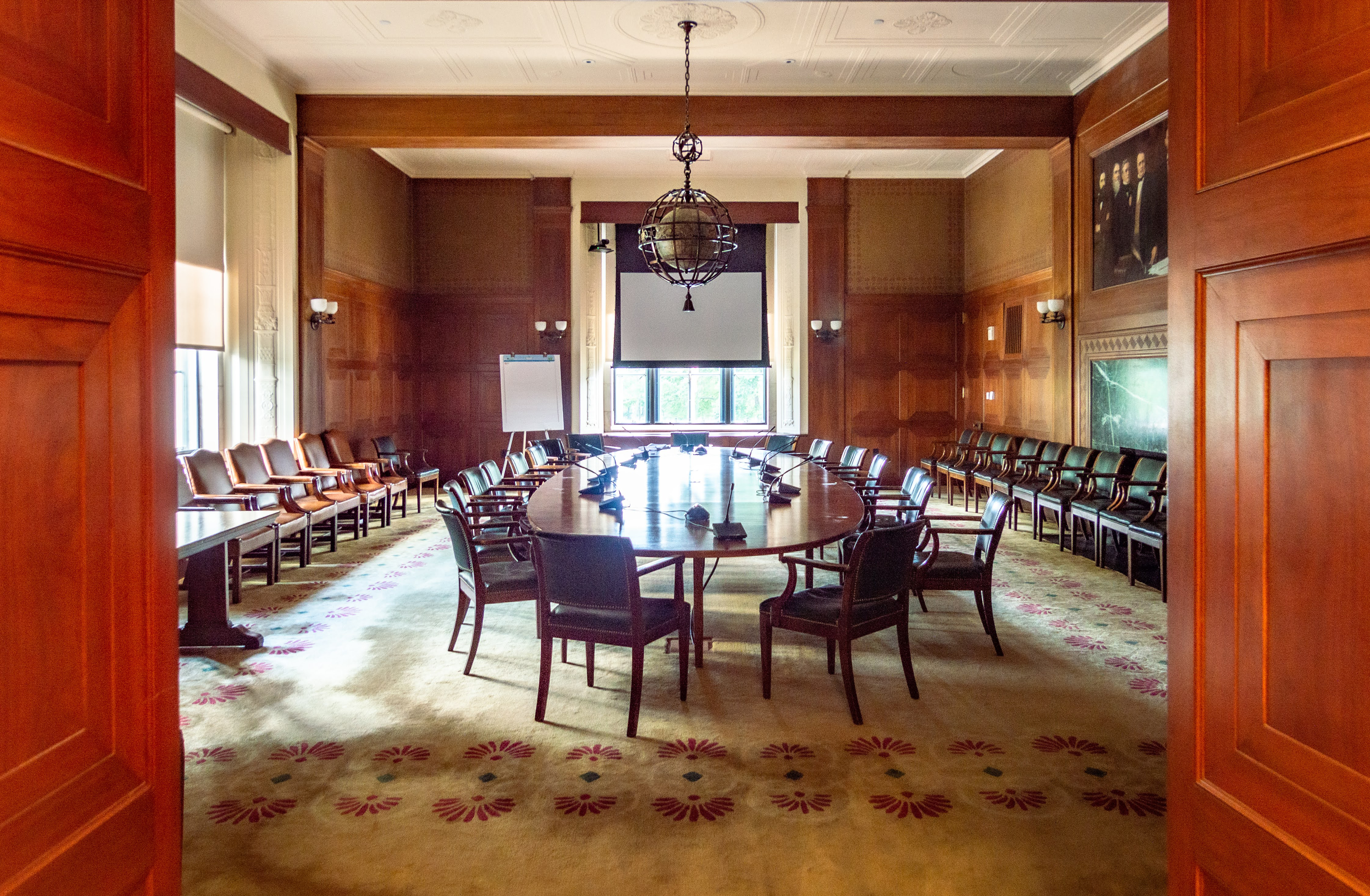 A grand room with a large conference table.