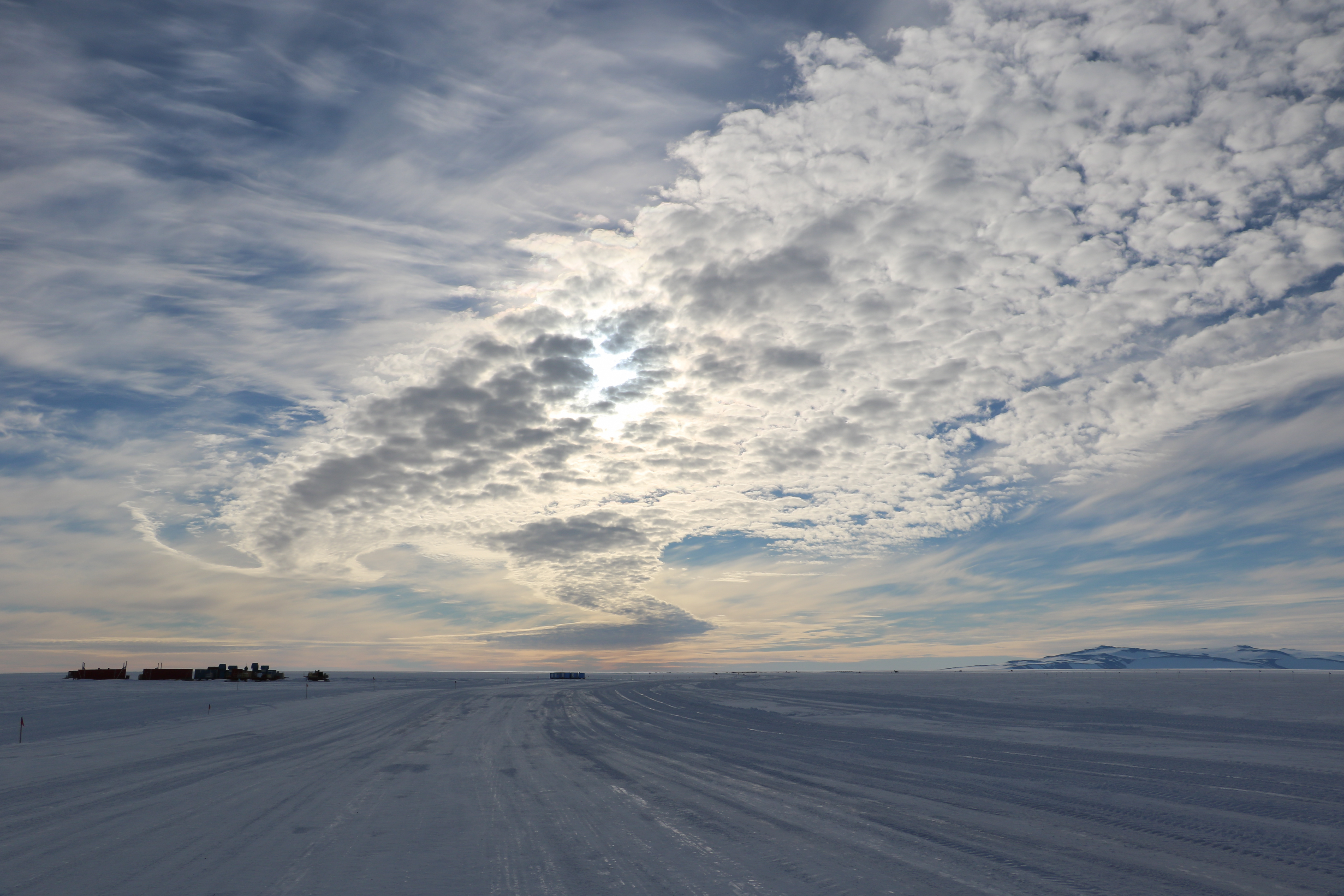 A cloudy sky over a snowy landscape.