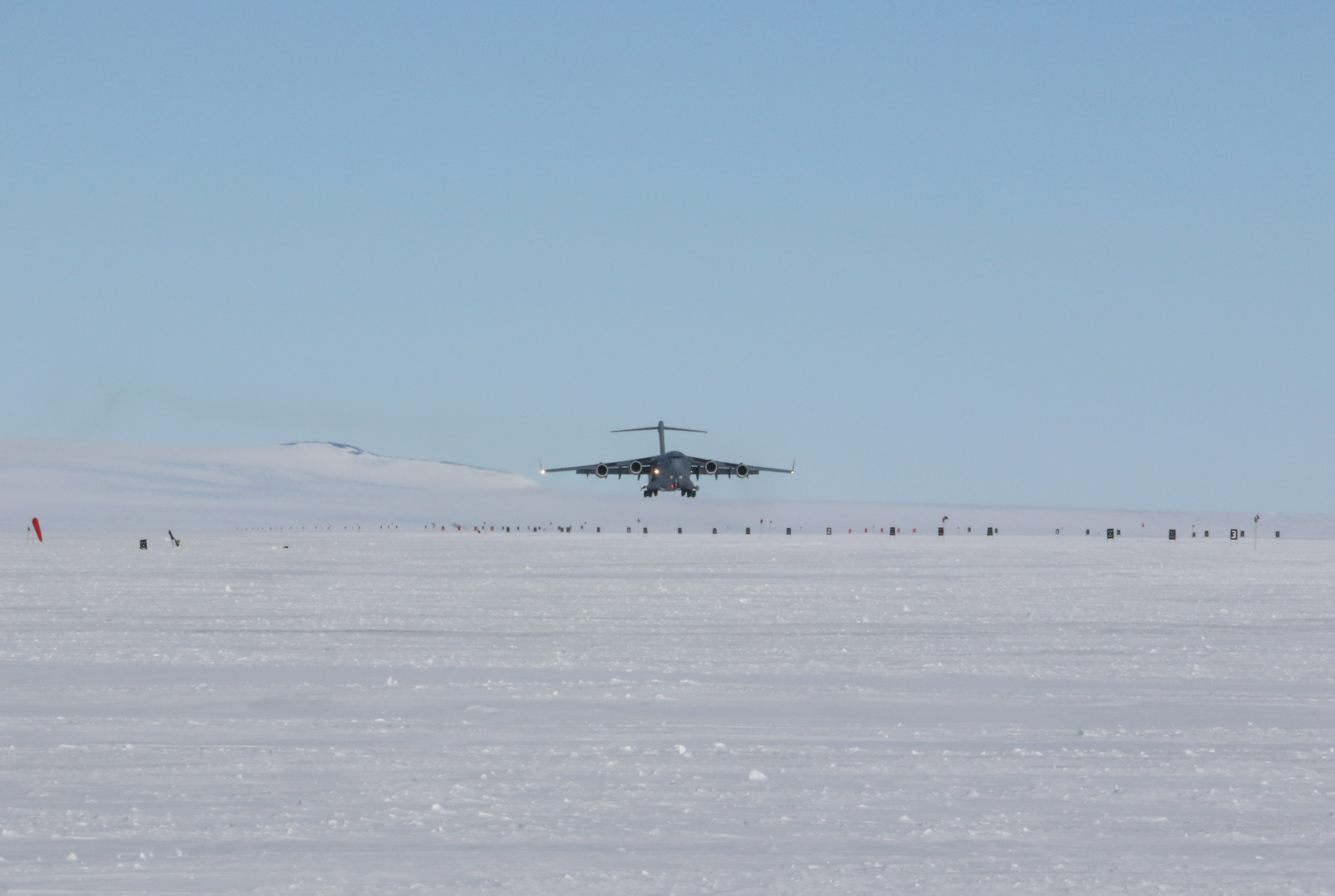 An airplane landing on a frozen runway.