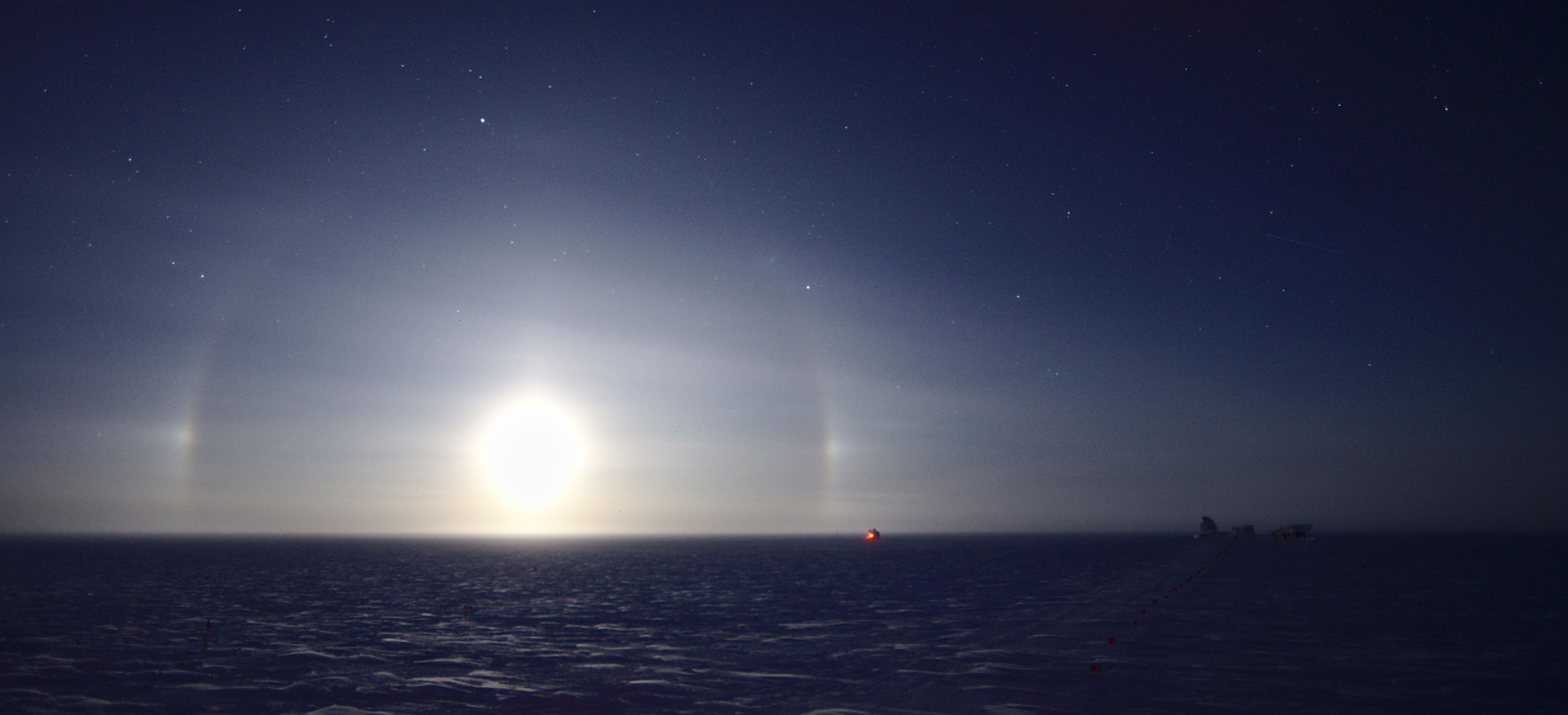 The moon with a halo of light surrounding it.