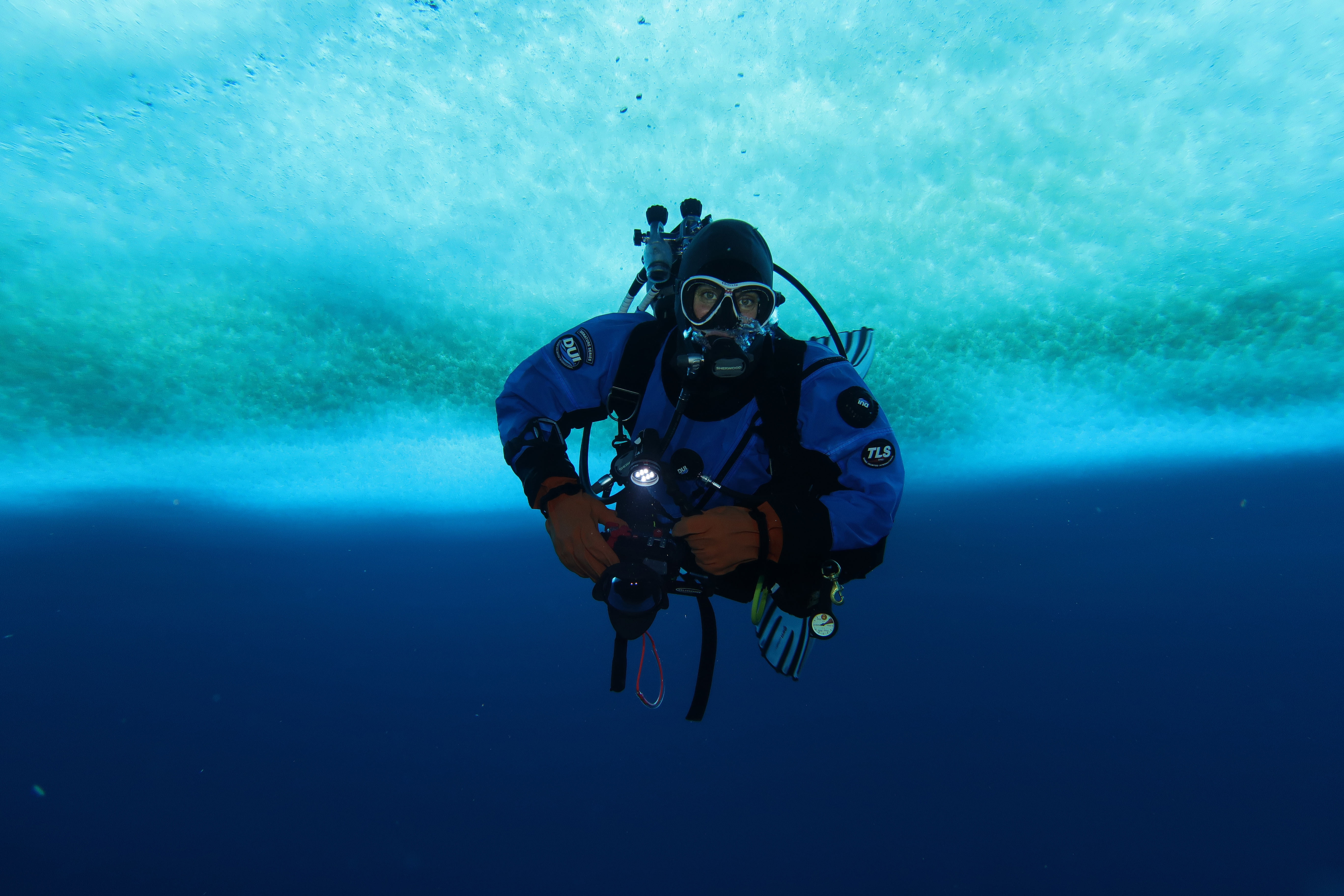 A diver underwater with a camera.