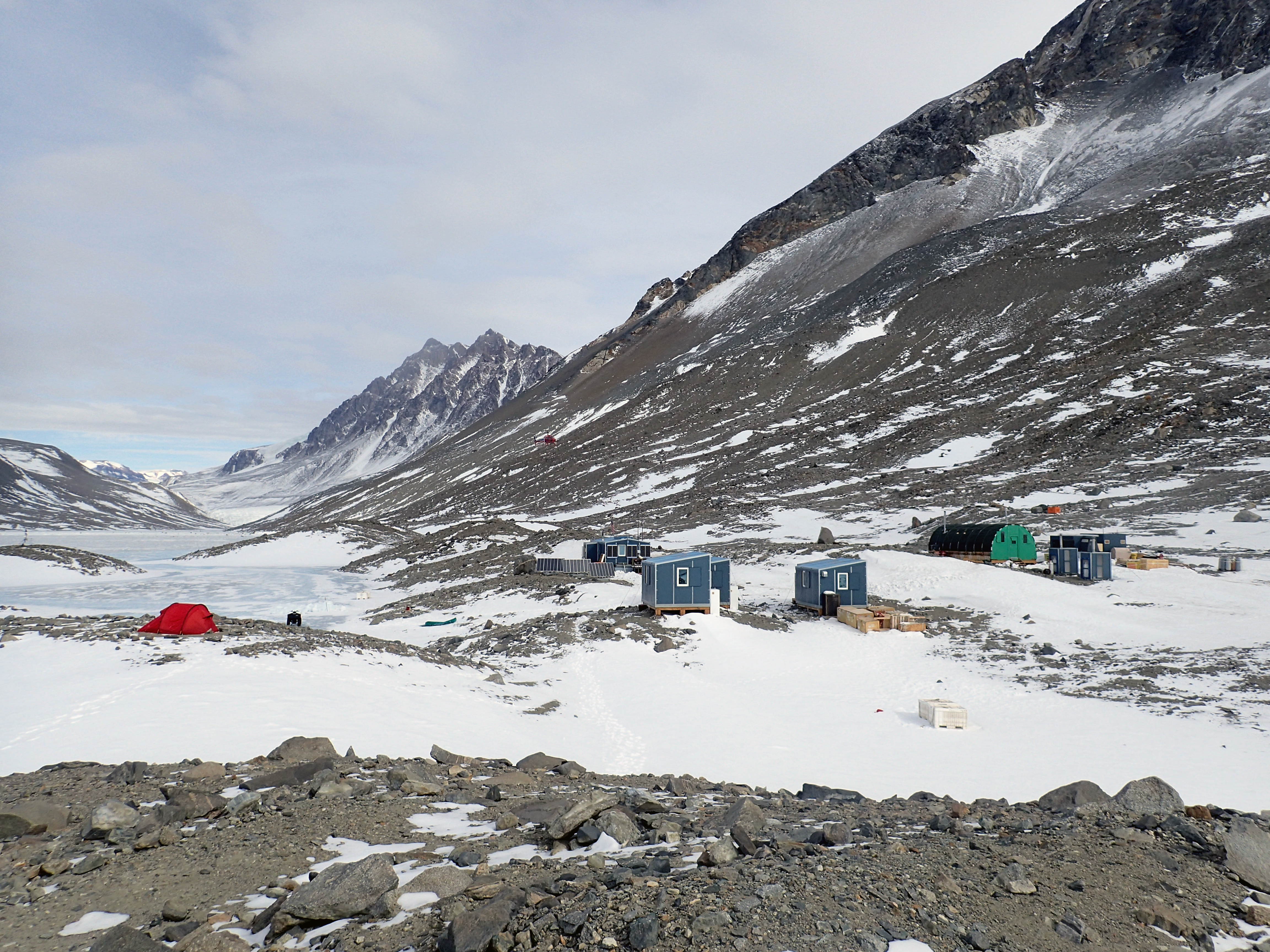 Several small buildings in a rocky valley.