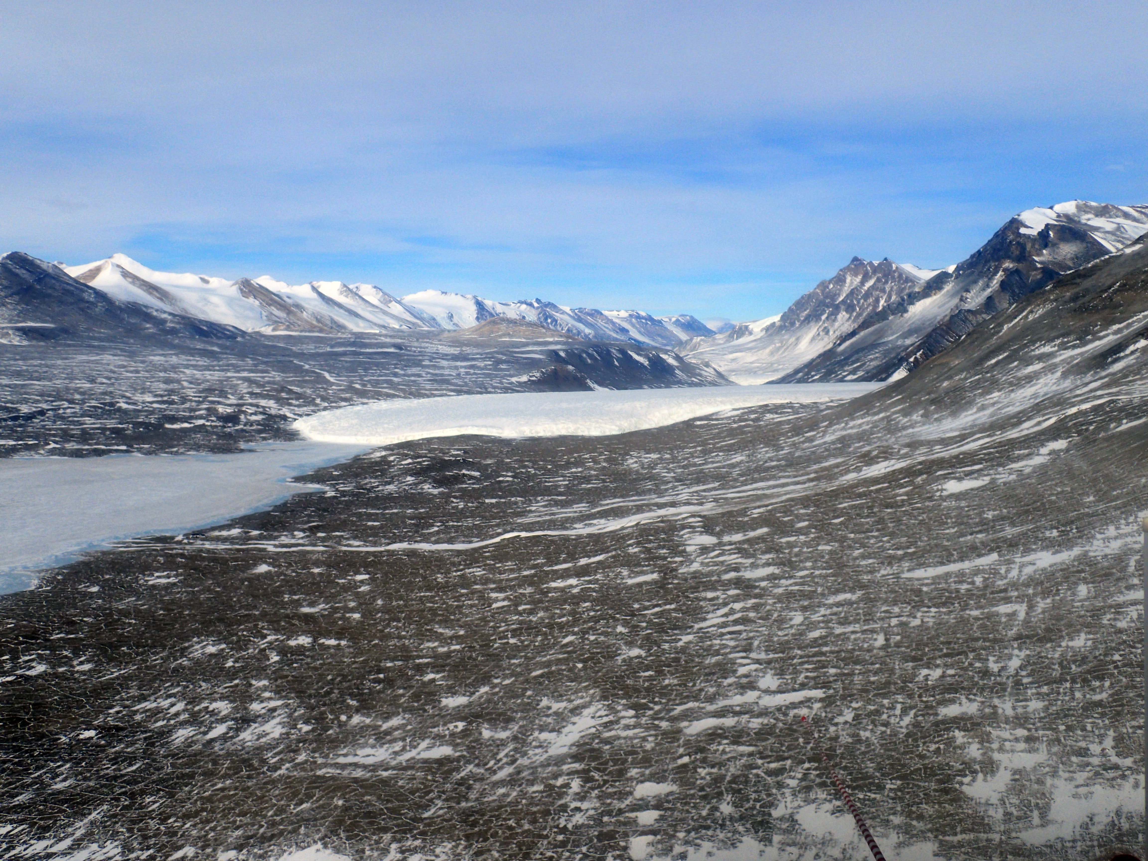 A wide valley with a glacier.