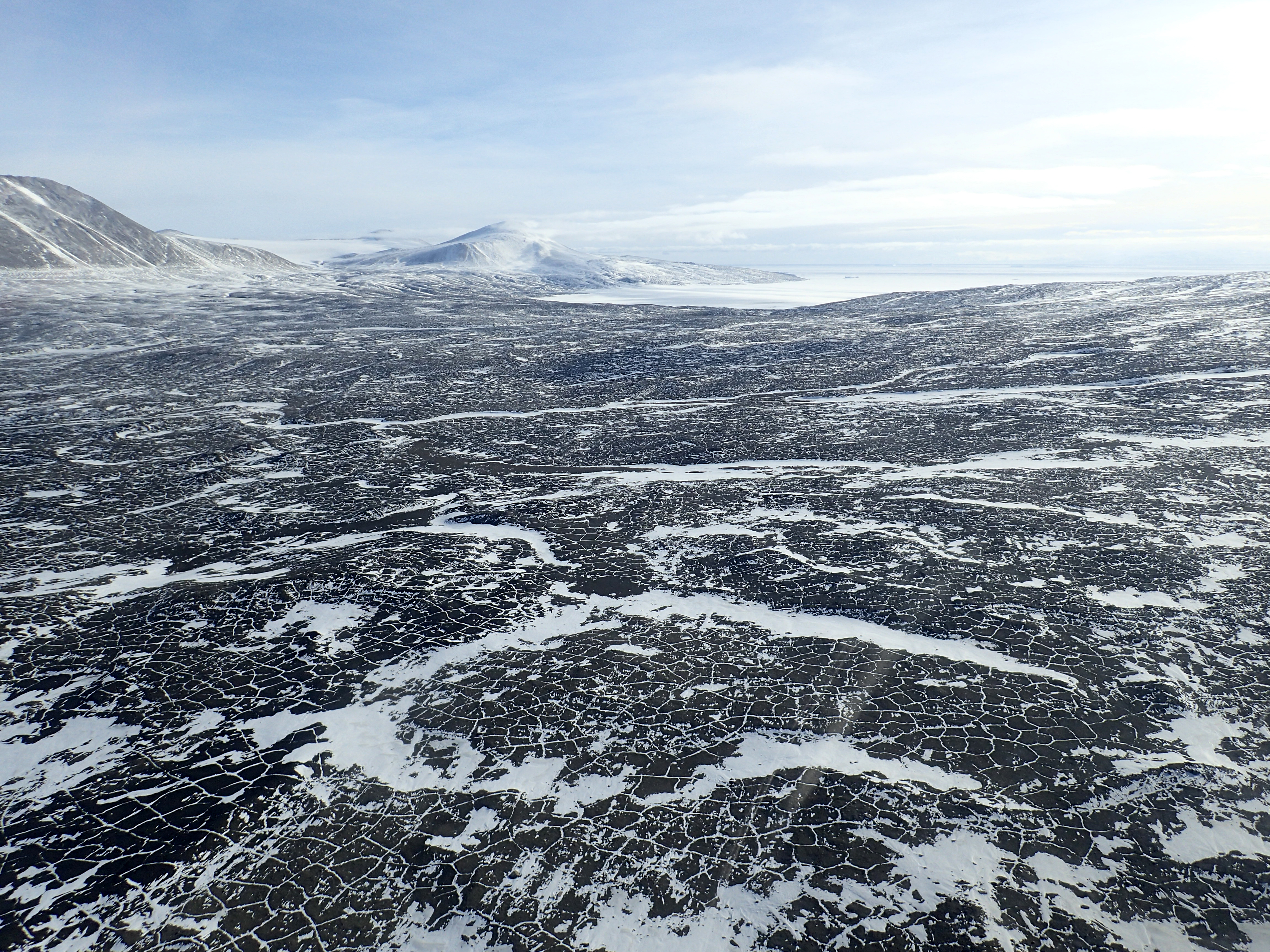 A snow-swept dirt valley floor.