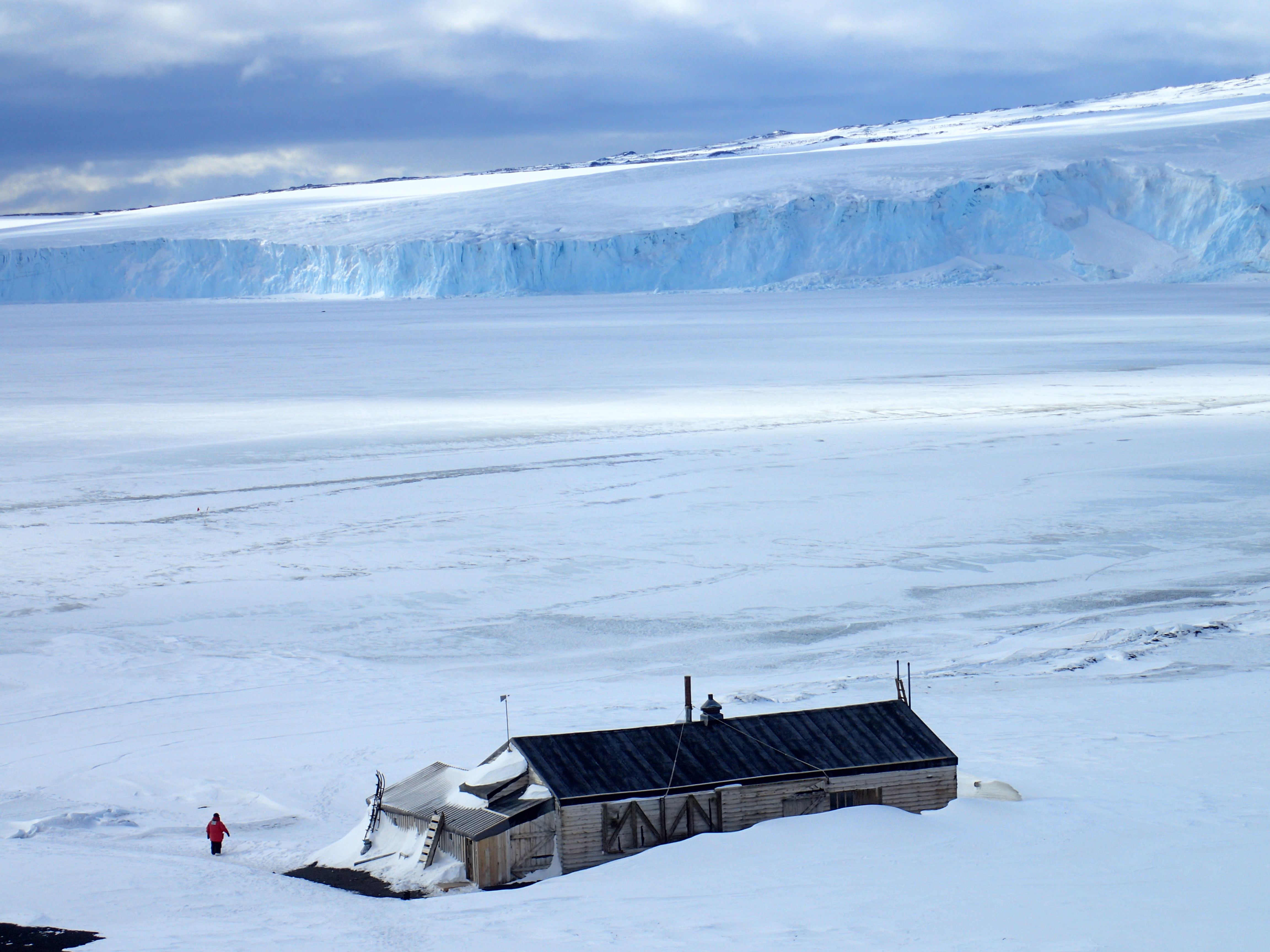 A small building in a snow-covered landscape.