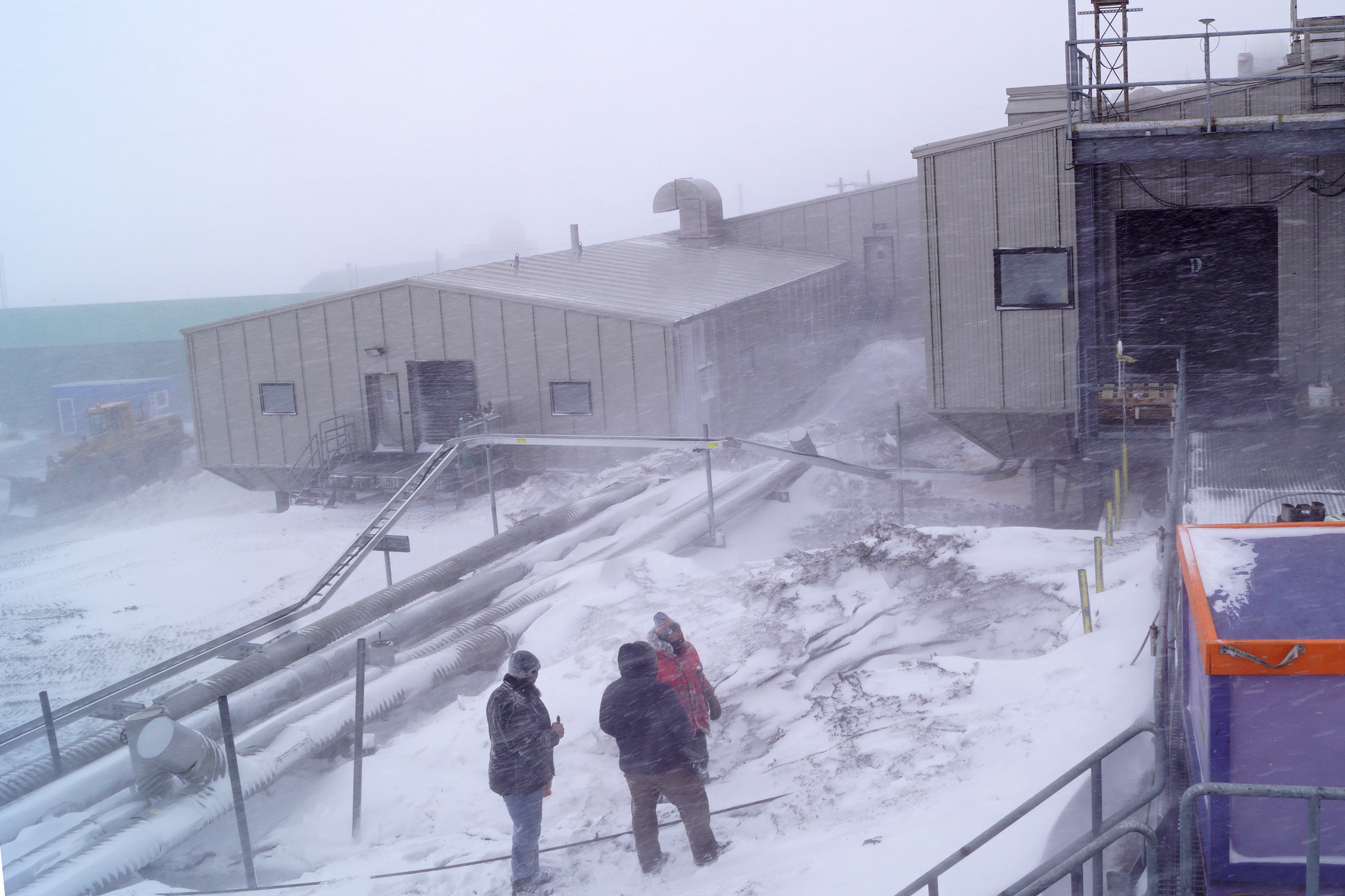 People working outside in snowy weather.