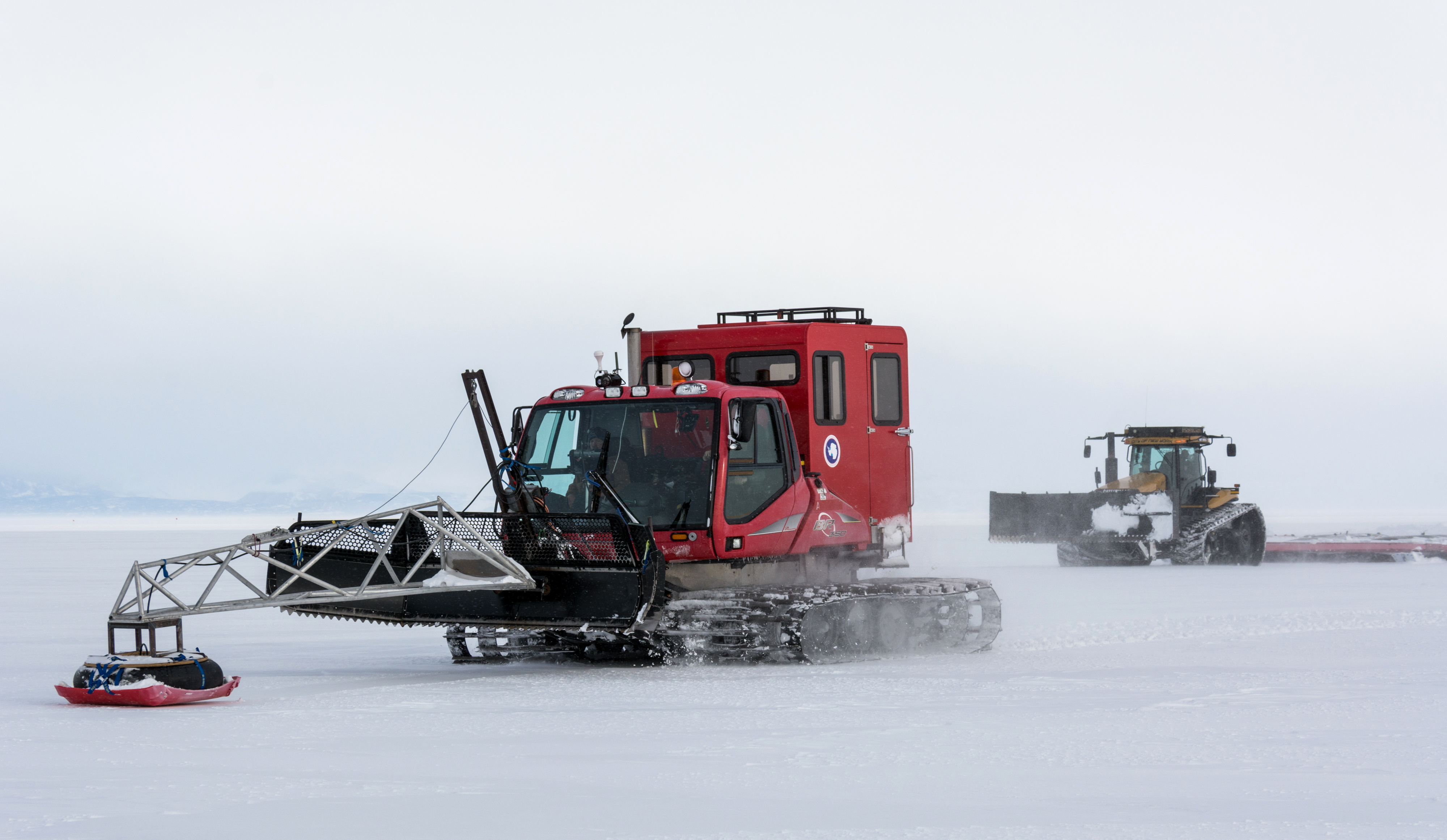 Large tractors on snow.