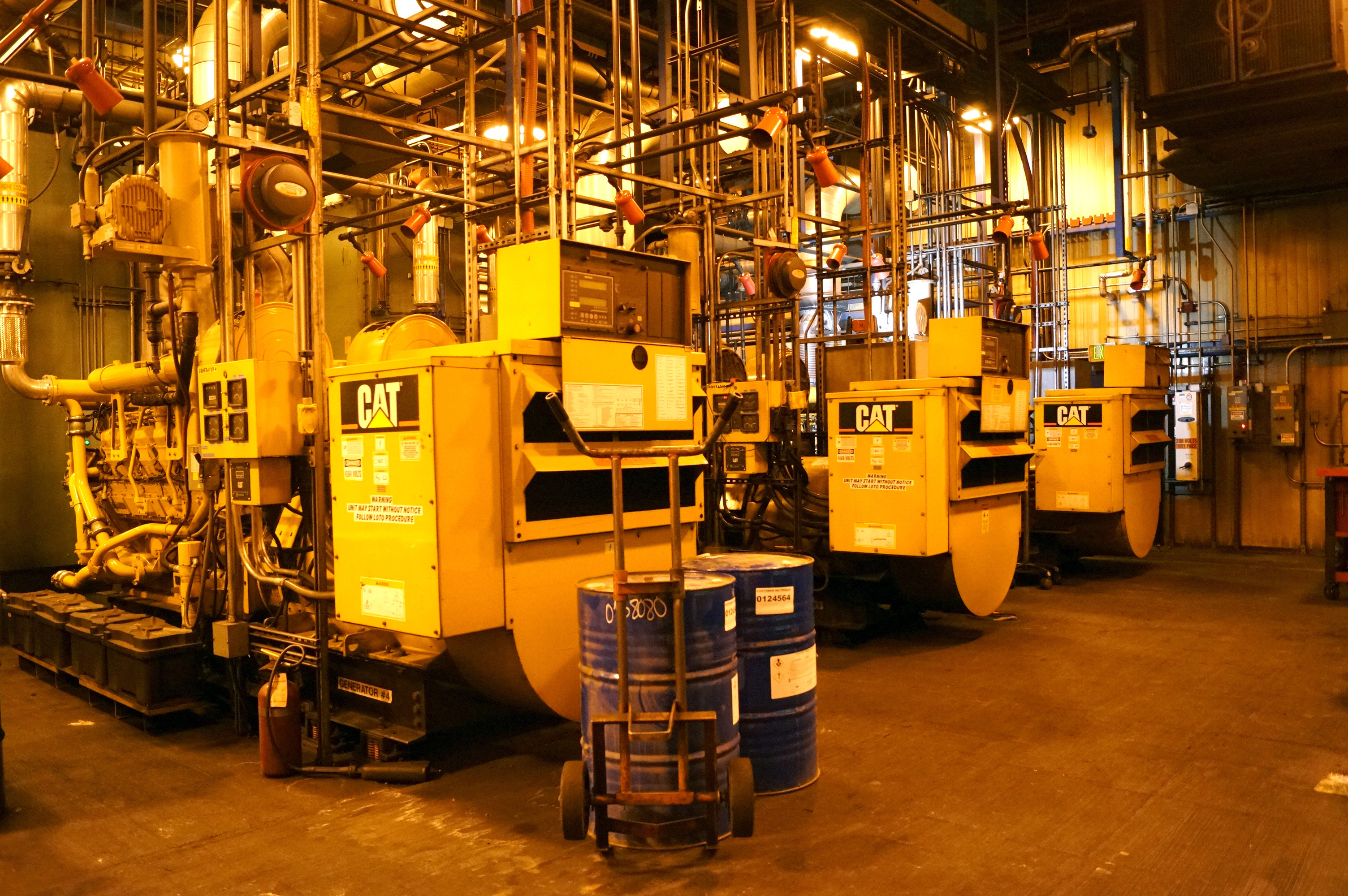 Three large Caterpillar generators in a power plant.