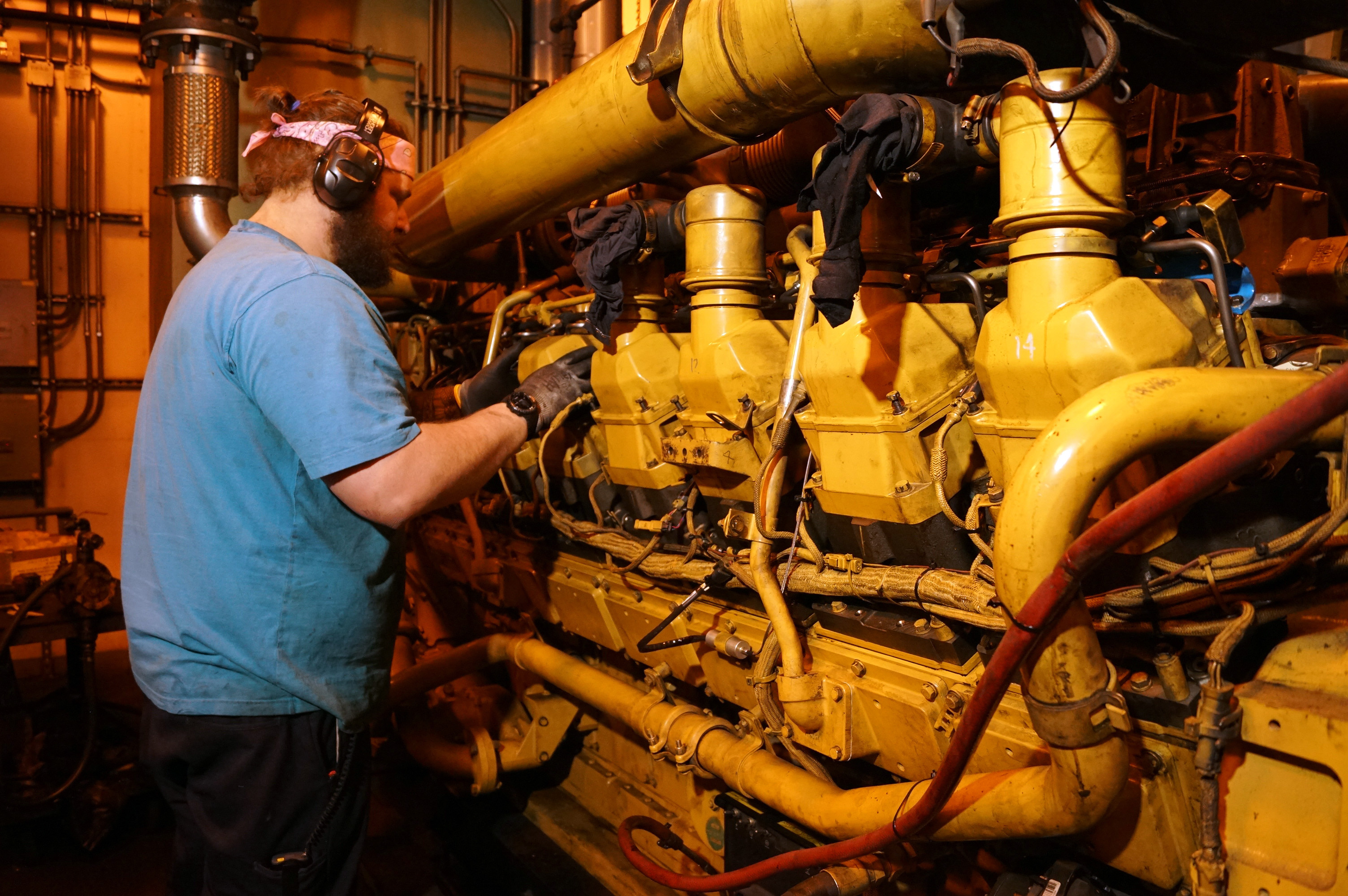 A mechanic works on power plant generators.